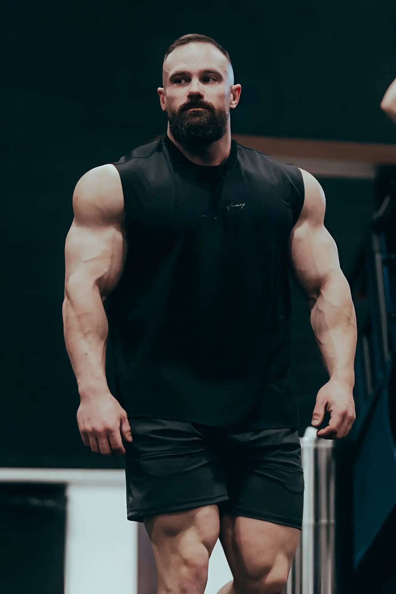 Black sleeveless JN Active muscle tee featuring a subtle chest logo ideal for athletic performance and workouts