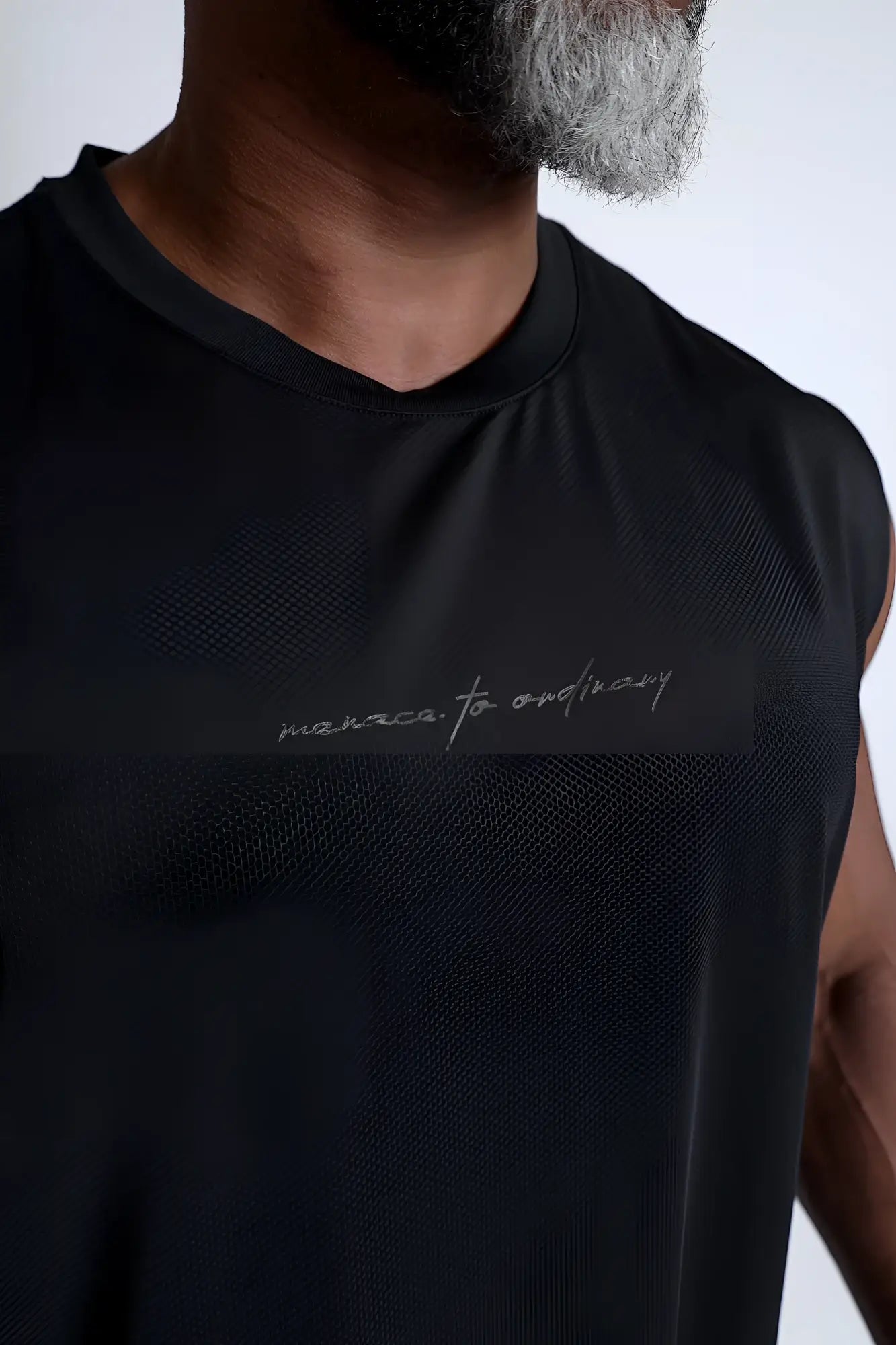 Jn Active Muscle Tee black sleeveless athletic top with subtle textured fabric and silver cursive embroidery on chest