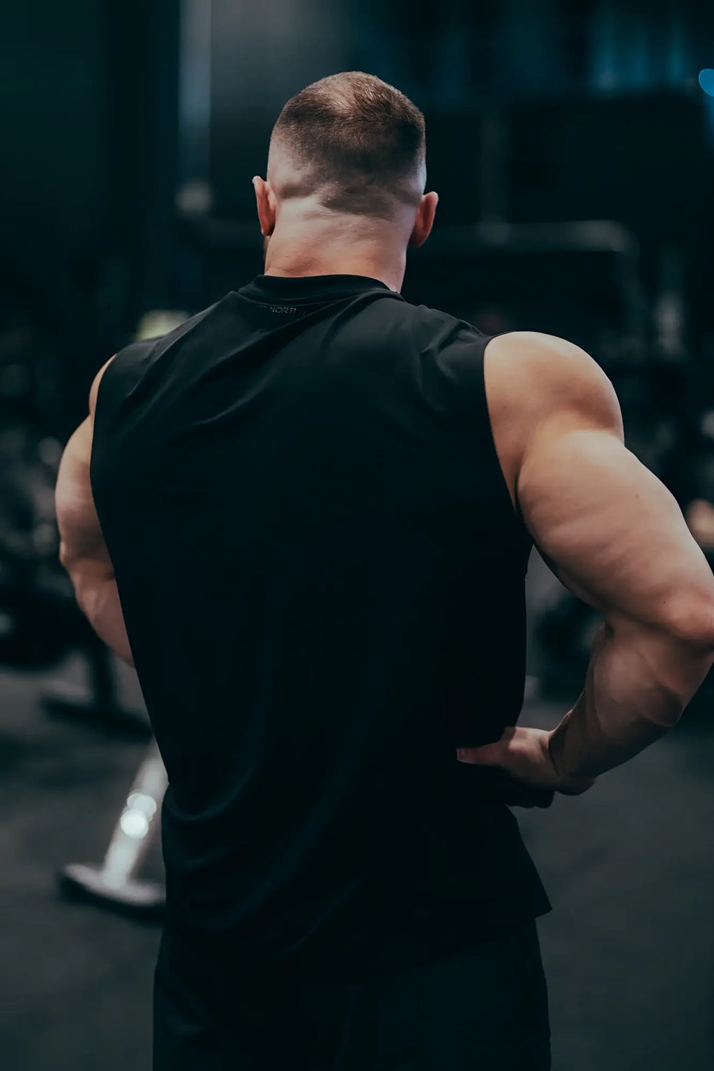 Black sleeveless JN active muscle tee made of breathable fabric for athletic and workout use