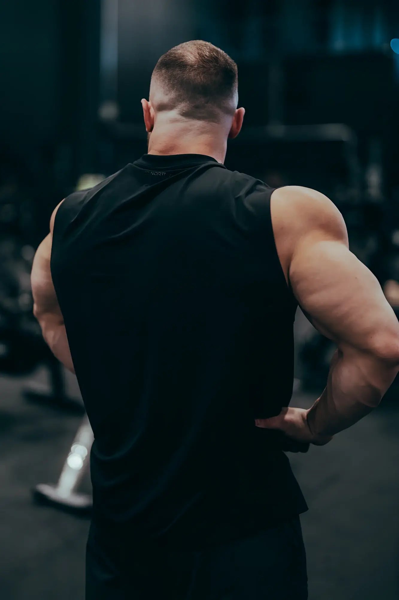Black sleeveless JN active muscle tee made of breathable fabric for athletic and workout use