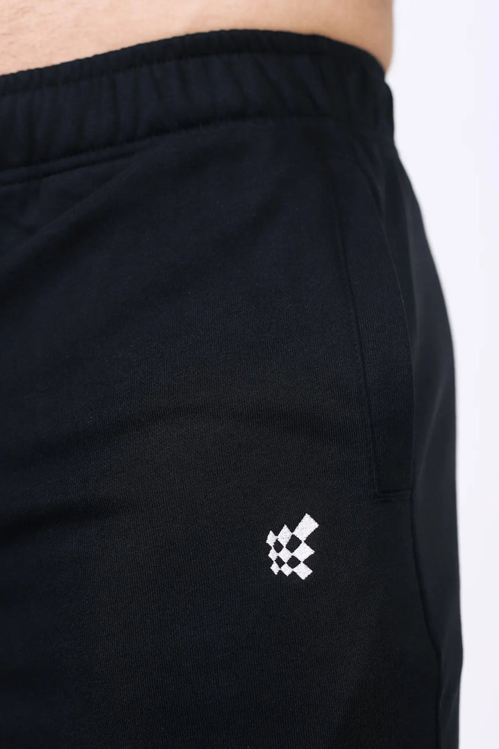 Jed North Lax straight cut joggers in black feature a subtle white geometric logo embroidered on the lower leg