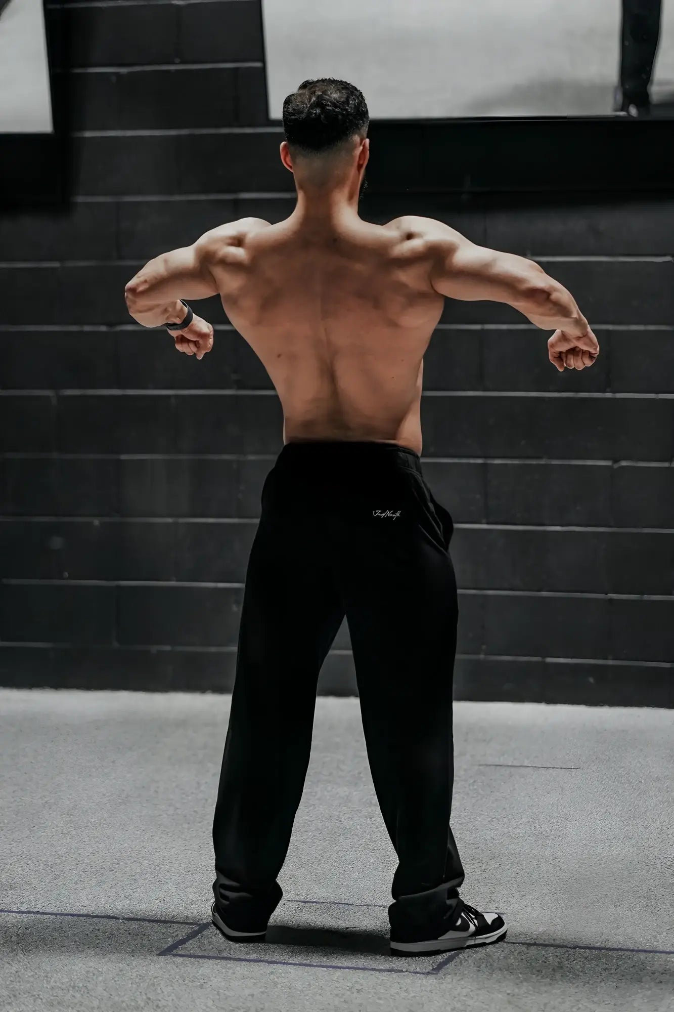 Jed north lax straight cut joggers in black with a subtle white logo on the left thigh made from comfortable fabric