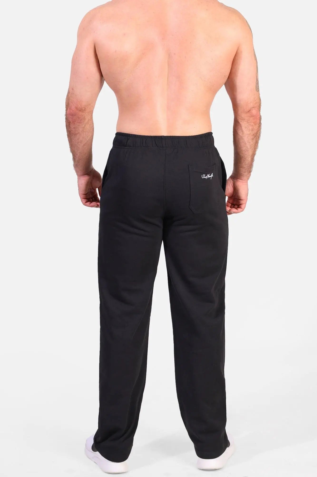 Back view of jed north lax straight cut joggers black athletic sweatpants with drawstring waistband and white logo