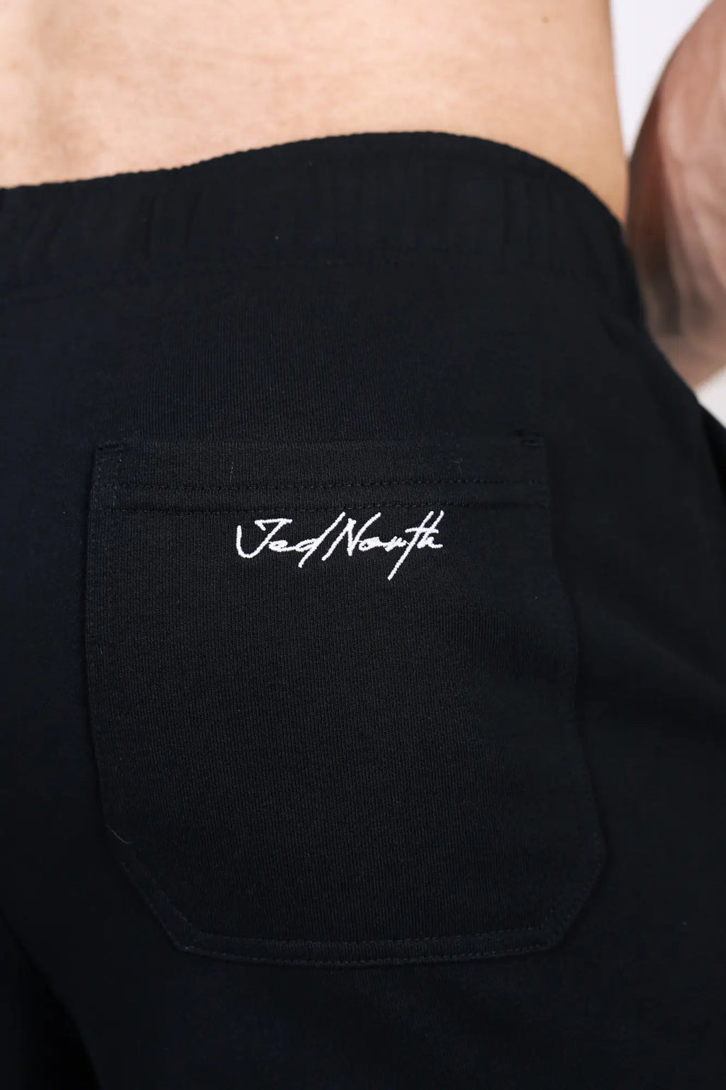 Black cotton jed north lax straight cut joggers with front pocket and white embroidered branding