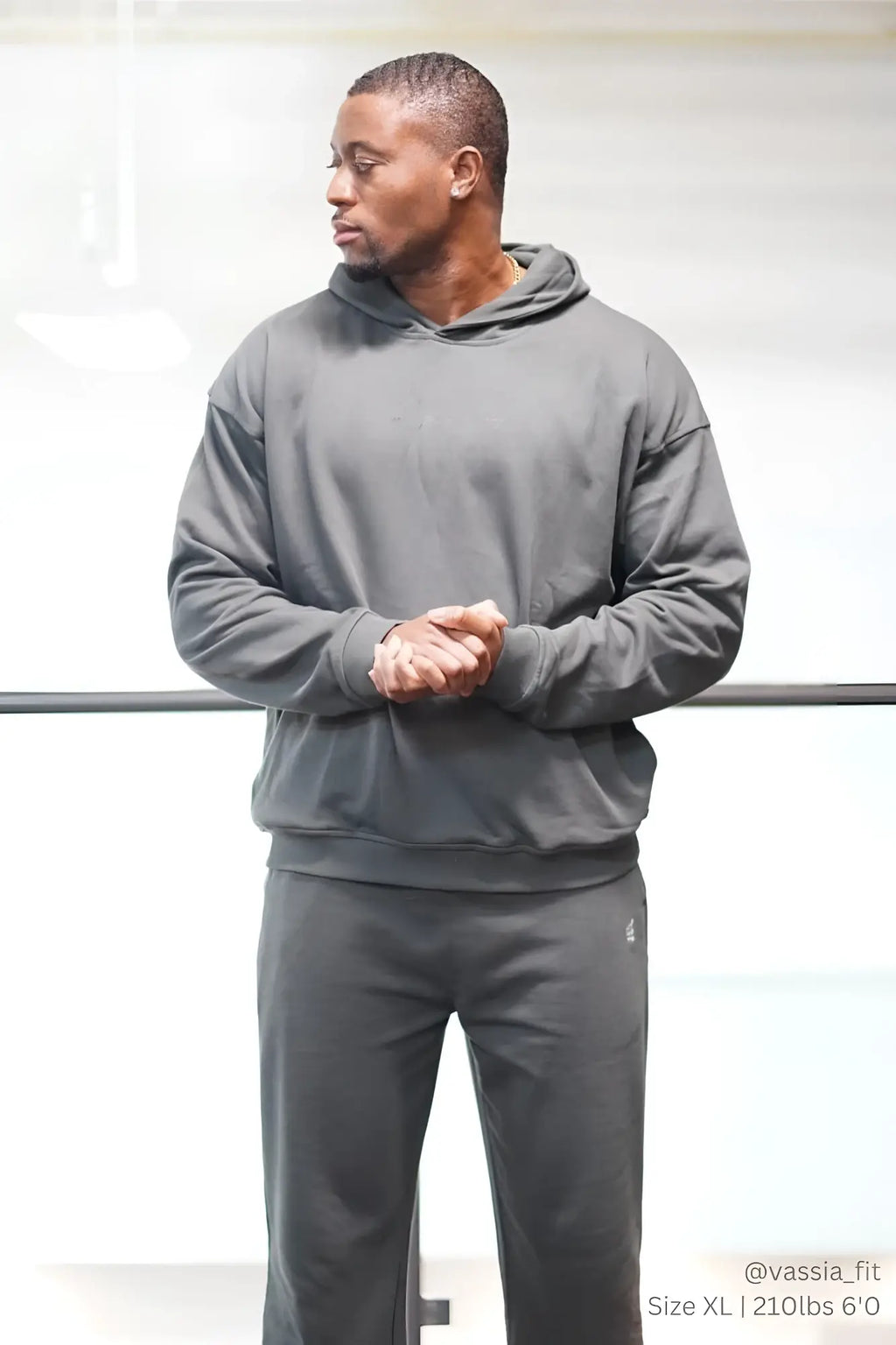 Dark gray hooded sweatshirt with long sleeves and drawstring hood paired with jed north lax straight cut gray joggers