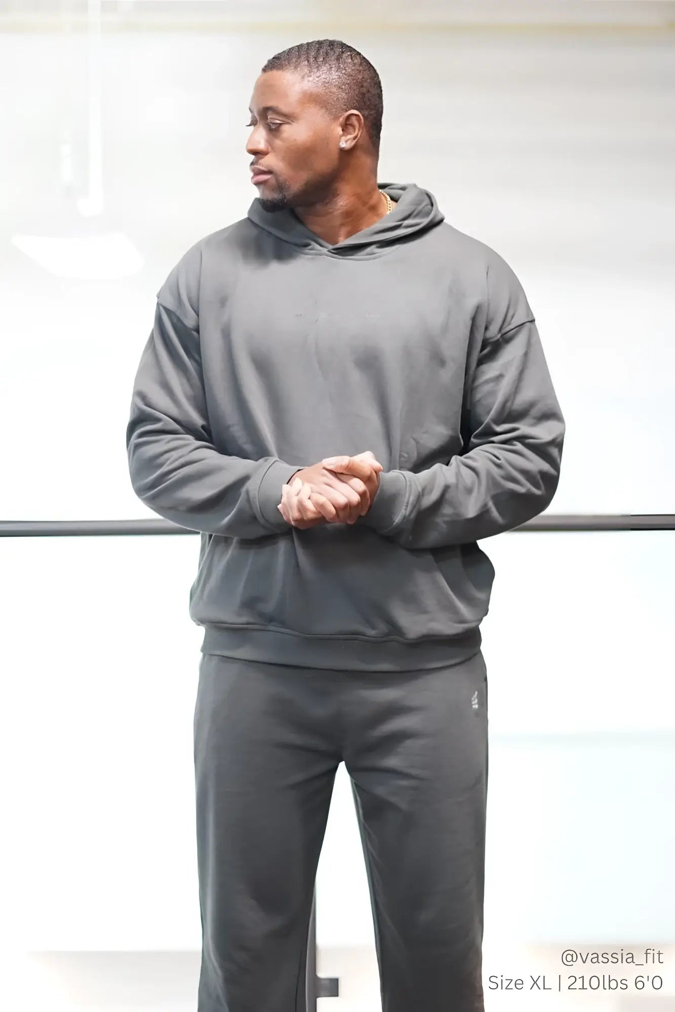 Dark gray hooded sweatshirt with long sleeves and drawstring hood paired with jed north lax straight cut gray joggers
