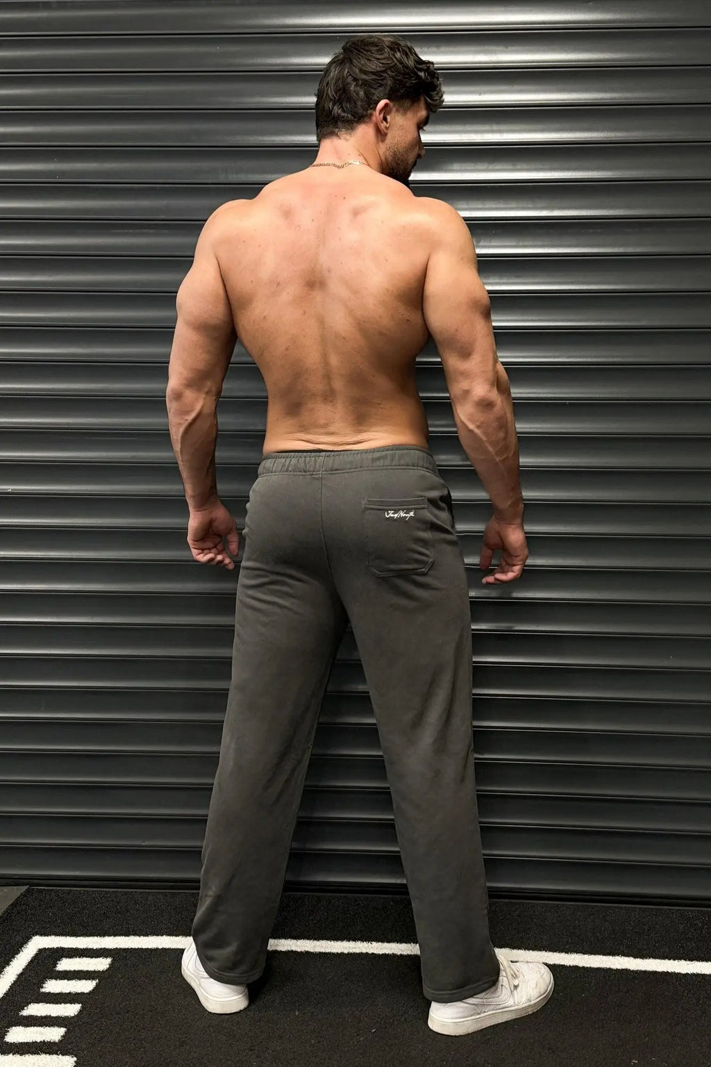 Back view of jed north lax straight cut joggers gray with comfortable fit and subtle logo on dark gray fabric pocket