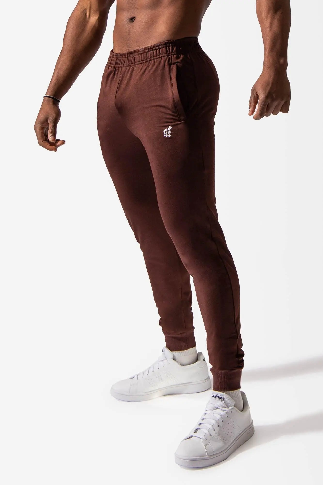 Jed North matrix tapered joggers in brown with elastic cuffs and a subtle white logo on the left thigh
