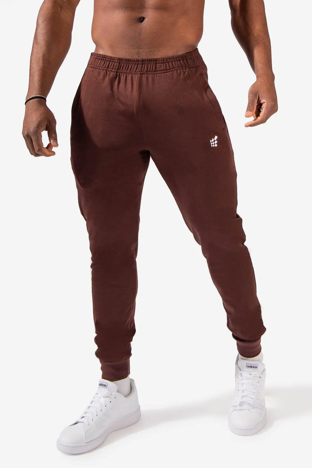 Brown jed north matrix tapered joggers with a subtle white logo on the thigh made from soft athletic material