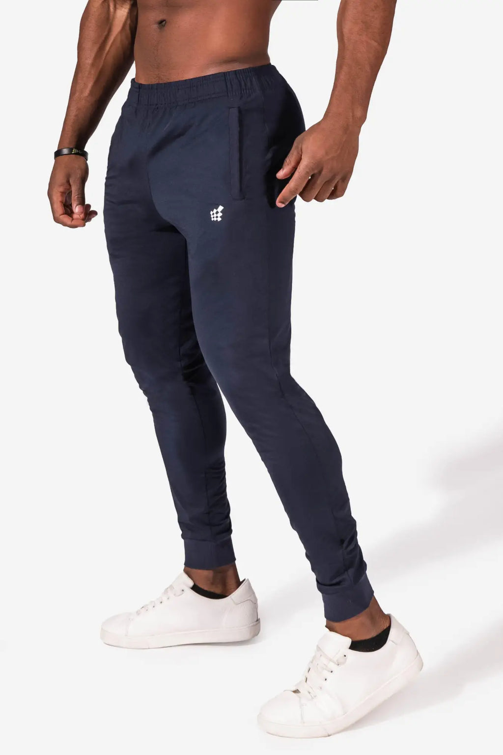 Navy blue jed north matrix tapered joggers featuring a subtle white logo on the thigh for athletic wear
