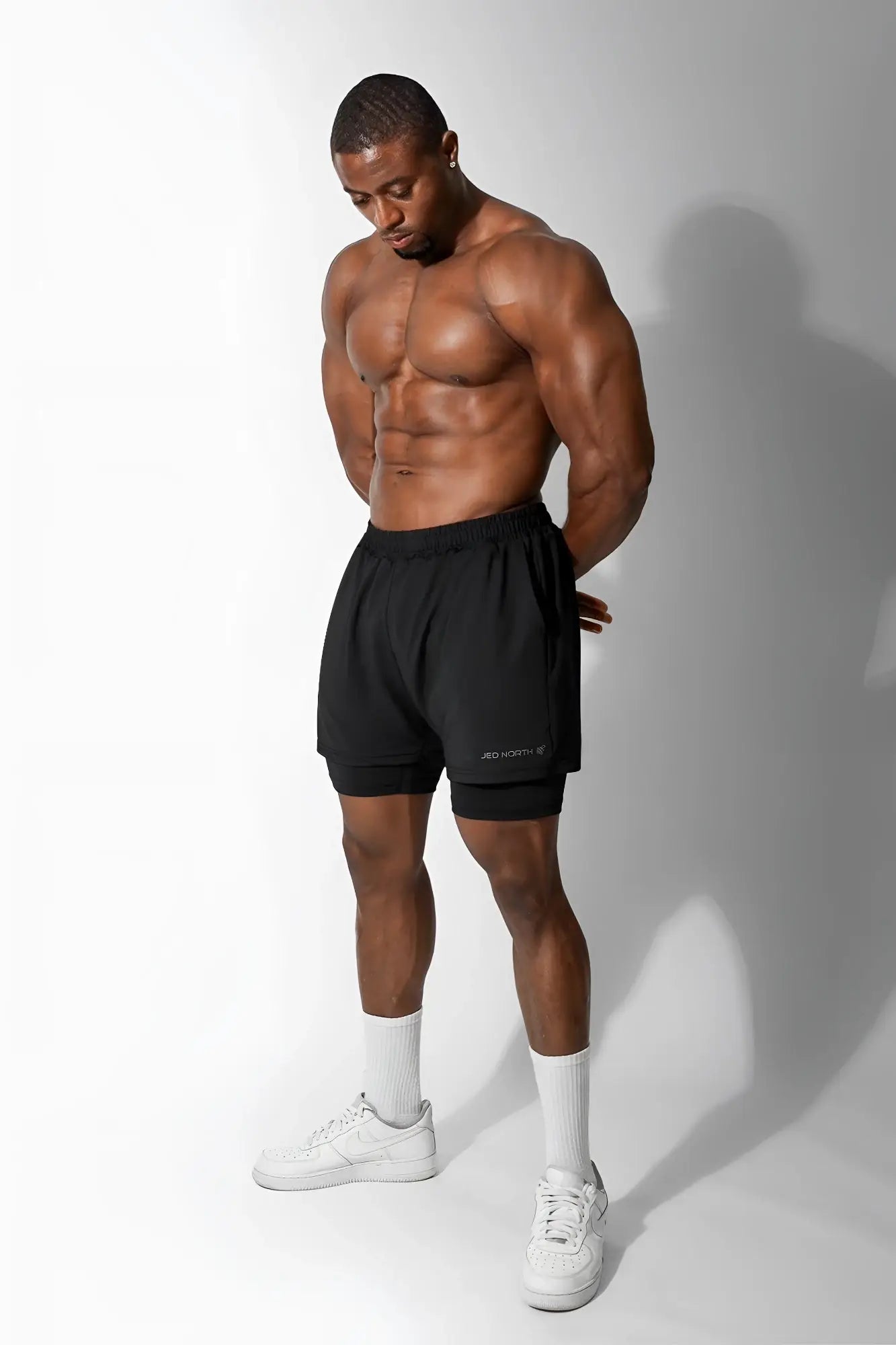 Jed North men’s 2-in-1 7 inch gym shorts in obsidian black with subtle logo on lower left leg for athletic use