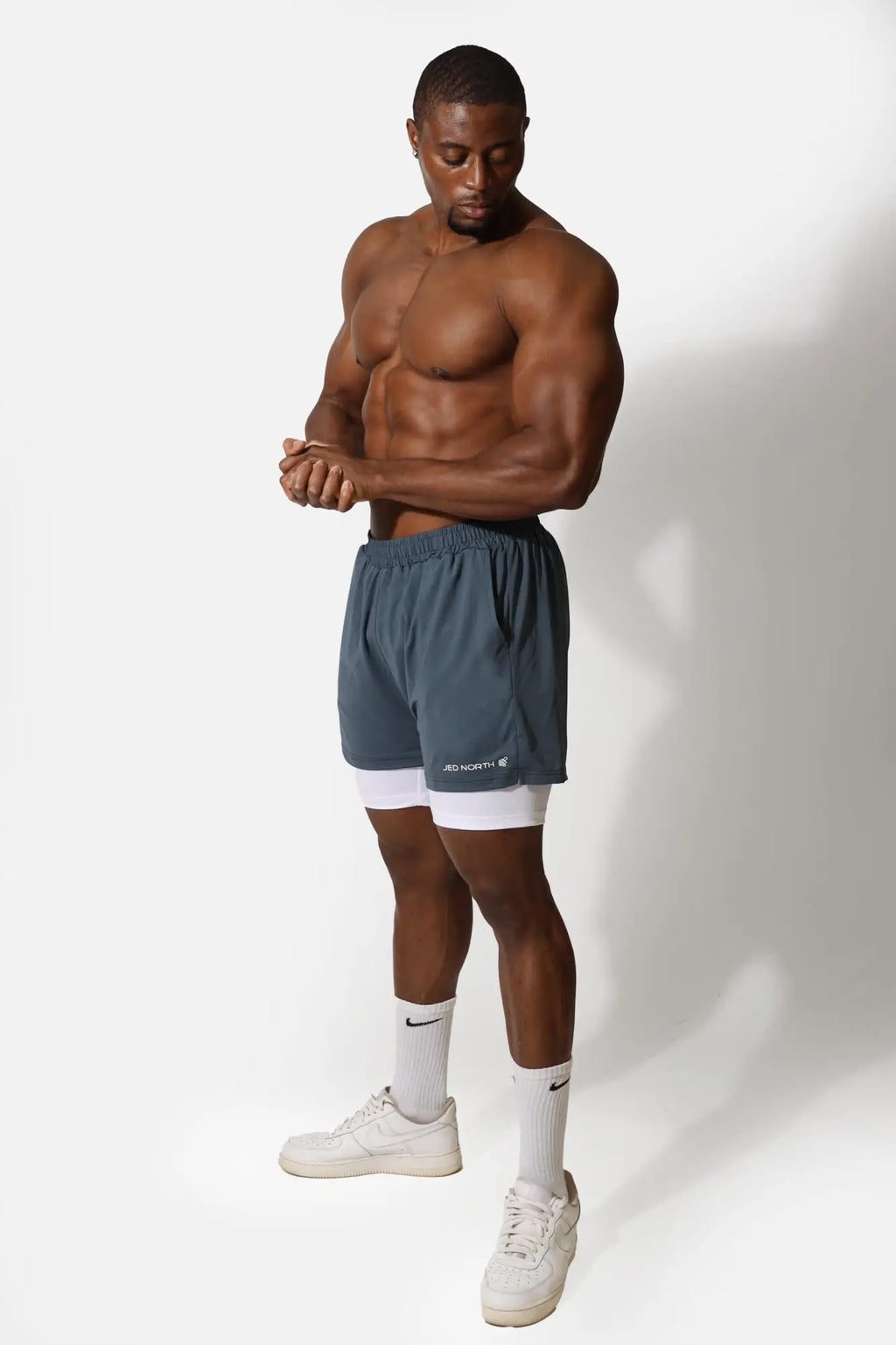 Jed North men’s 2-in-1 gym shorts in storm gray with white inner layer and adnorth logo on lower left leg