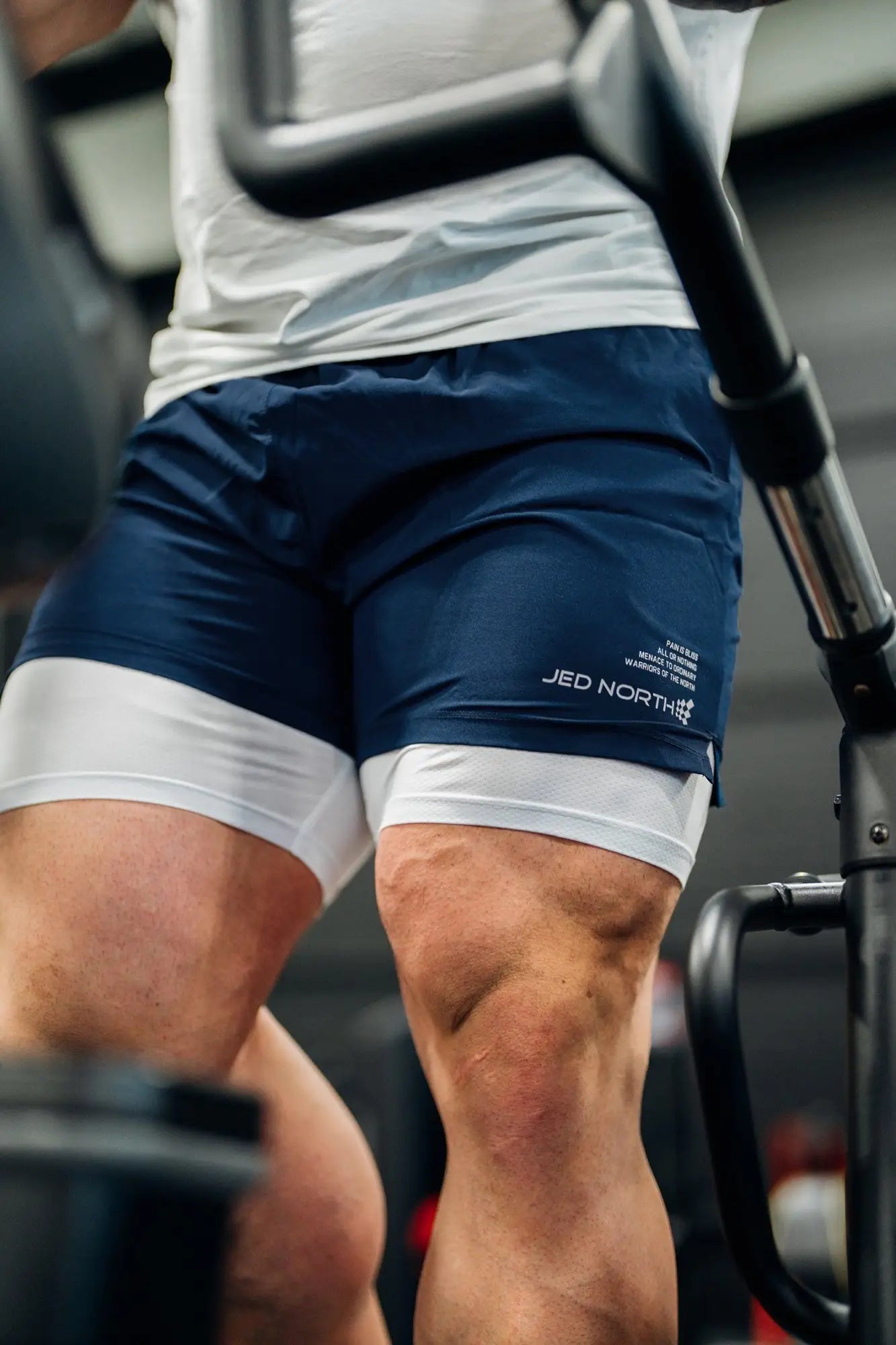 Navy blue and white two-layer Jed North men’s 2-in-1 active 5-inch training shorts with Jed North branding on leg