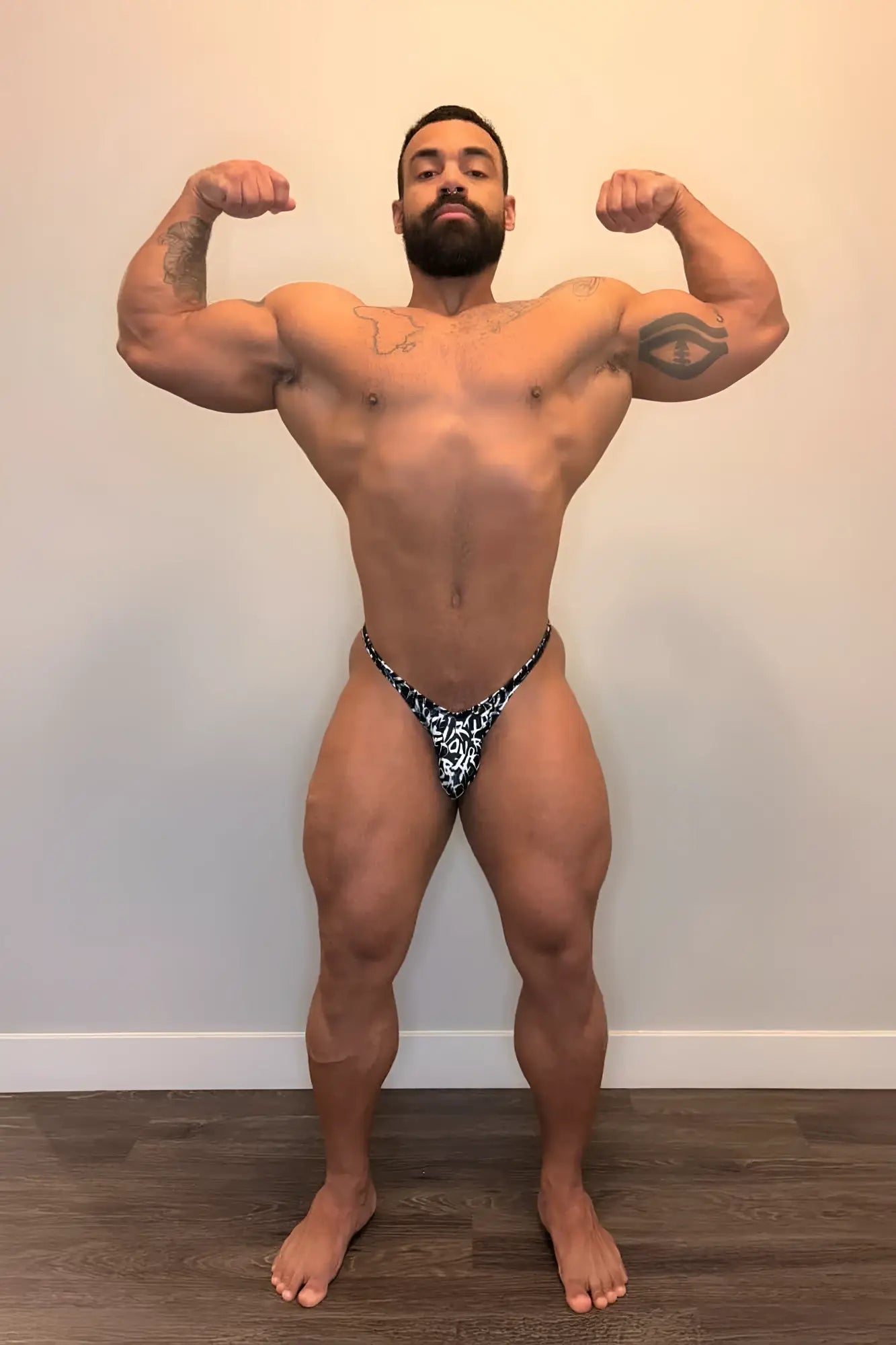Men’s bodybuilding posing trunks chaotic black and white patterned thong with lace-like design front view