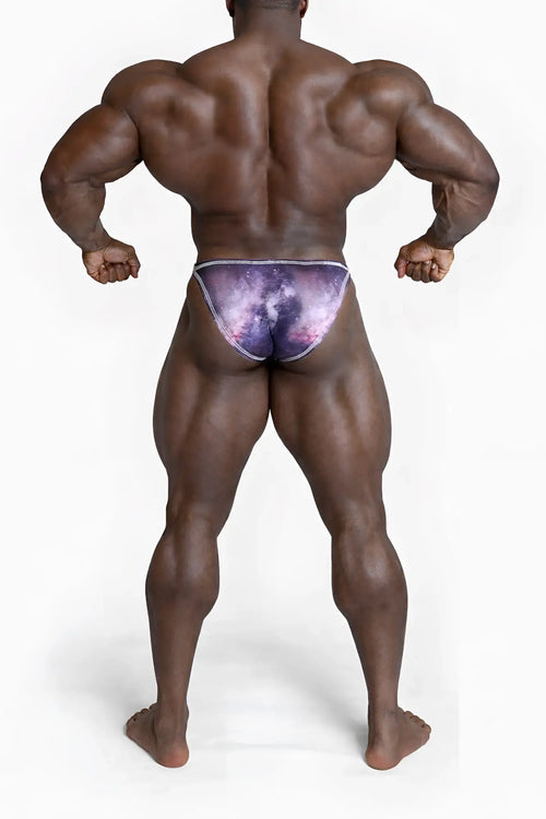 Men’s bodybuilding posing trunks with a purple and pink galaxy pattern and subtle white trim