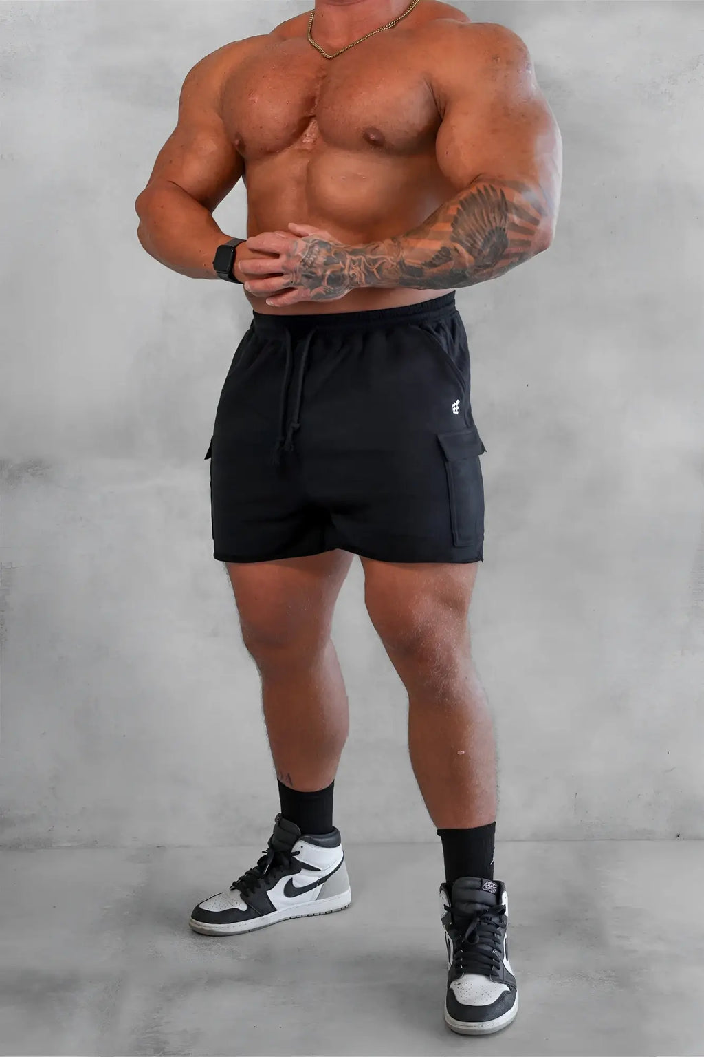 Men’s black cargo sweat shorts with side pockets and drawstring waistband made for athletic use