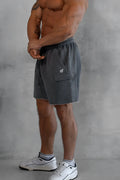 Men’s dark gray cargo sweat shorts with textured fabric and a small white logo on the thigh pocket
