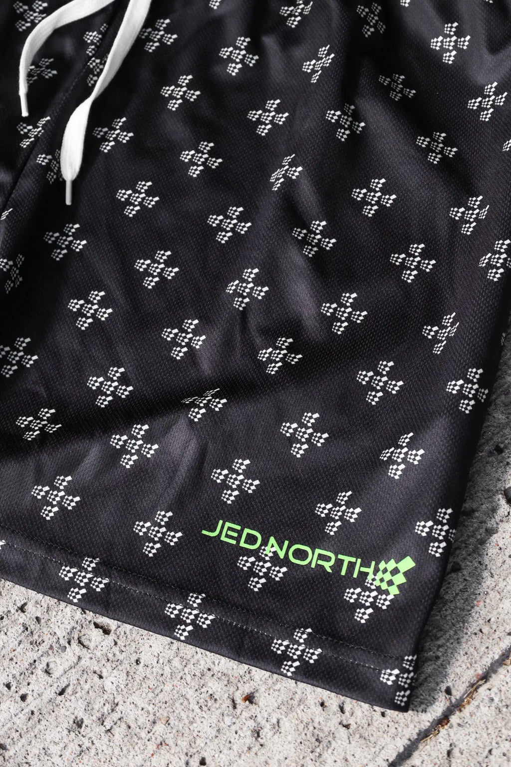 Jed North men’s fast-dry black athletic shorts with white checkered pattern and neon green branding for training