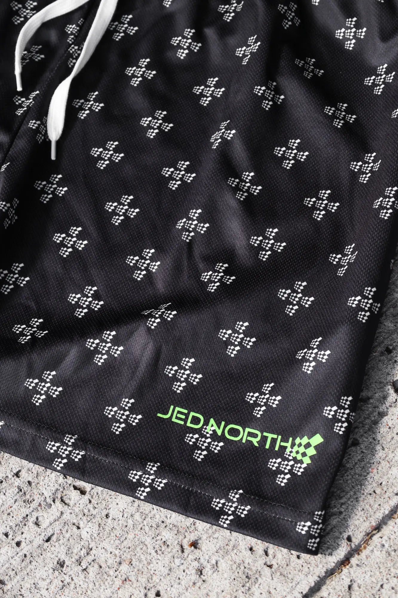Jed North men’s fast-dry black athletic shorts with white checkered pattern and neon green branding for training