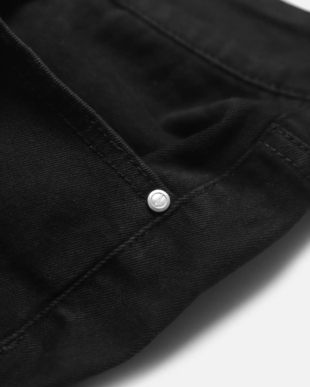 Men’s fitted stretchy black denim jeans with silver button and subtle branding for a comfortable stylish fit