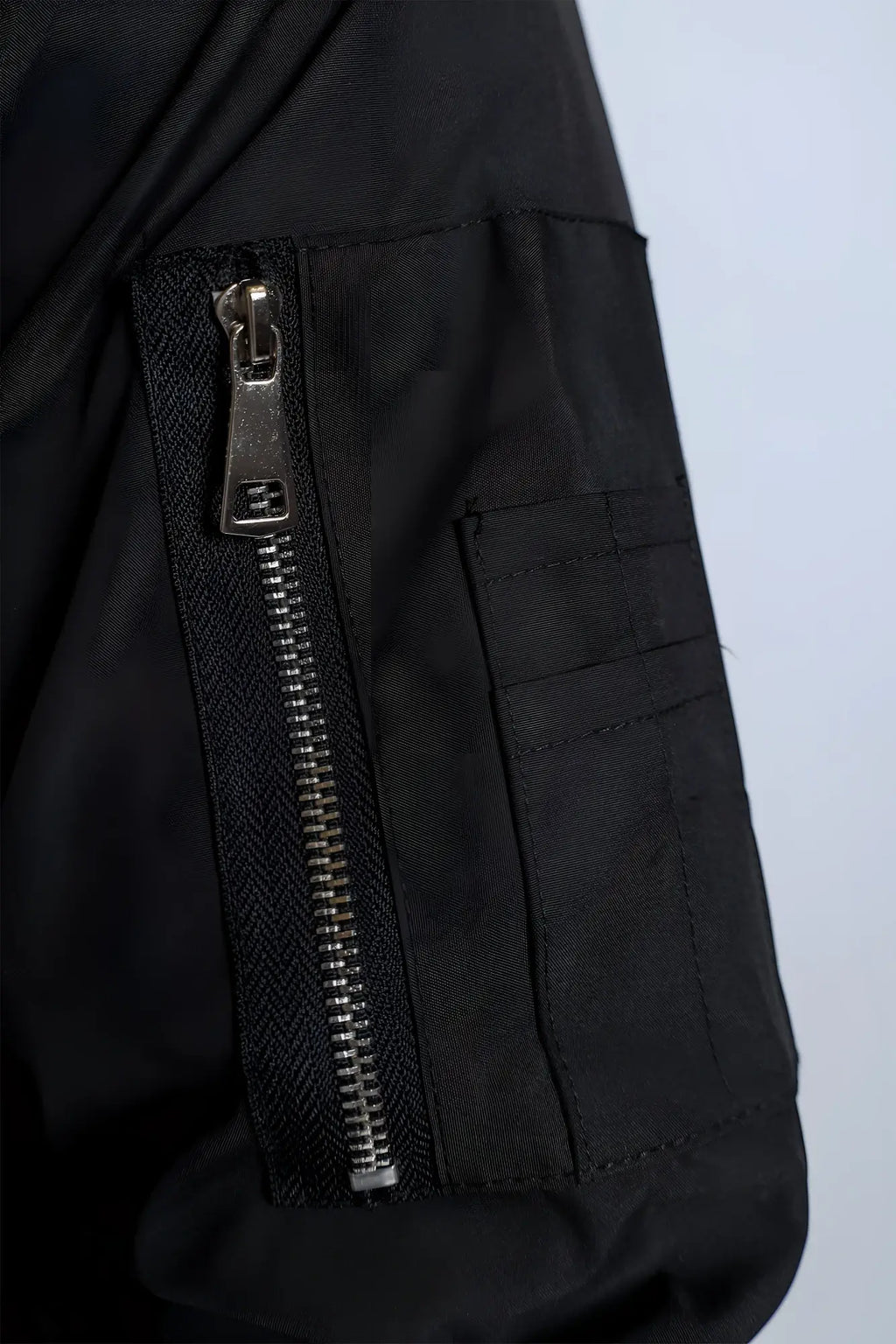 Men’s premium black nylon bomber jacket with silver zipper and reinforced stitching for durable style
