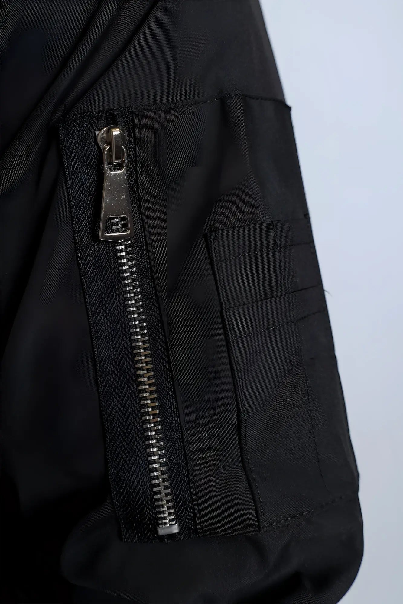 Men’s premium black nylon bomber jacket with silver zipper and reinforced stitching for durable style