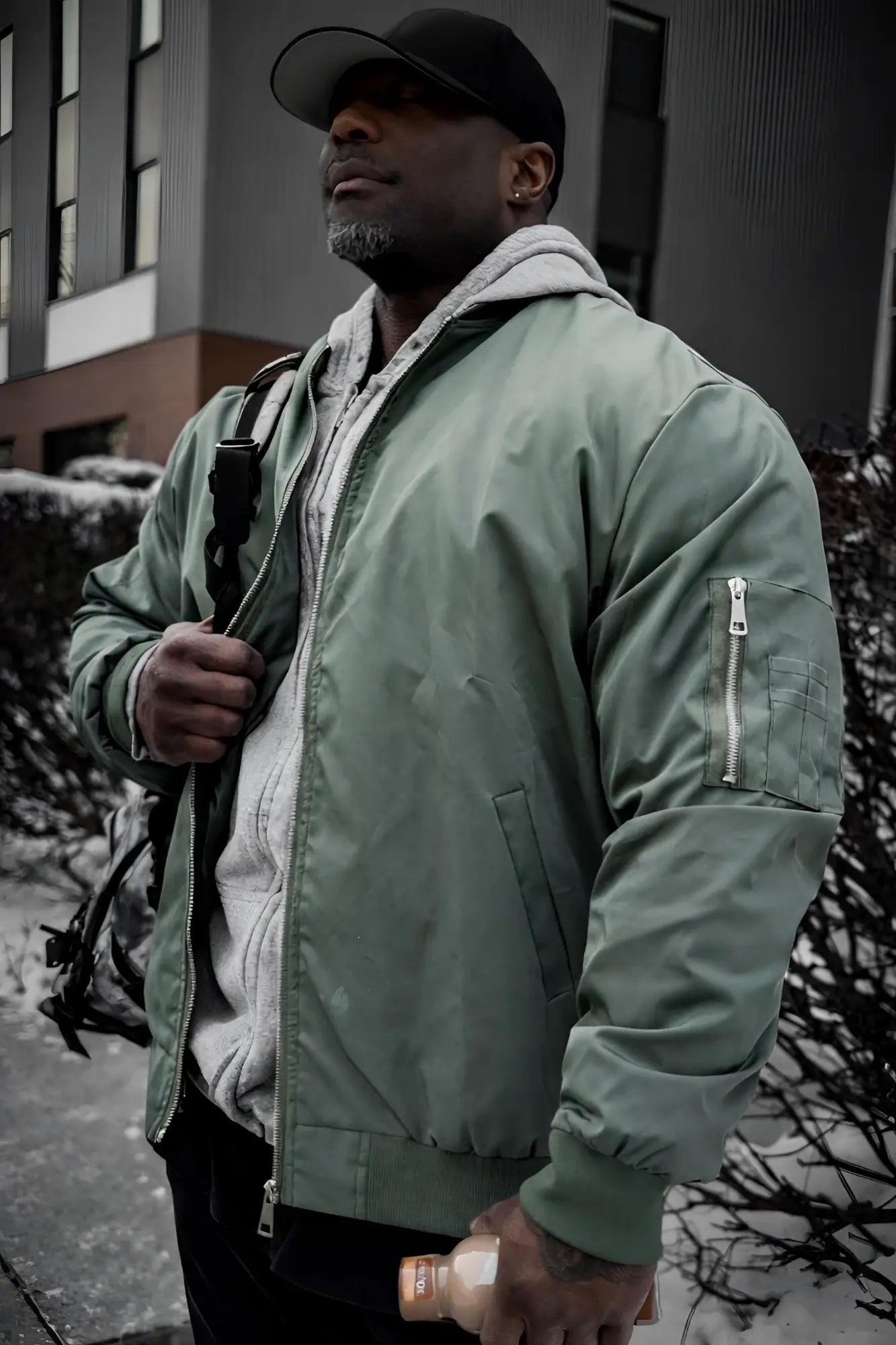 Men’s premium olive bomber jacket with gray fleece-lined hood and silver zippers for stylish warmth and comfort