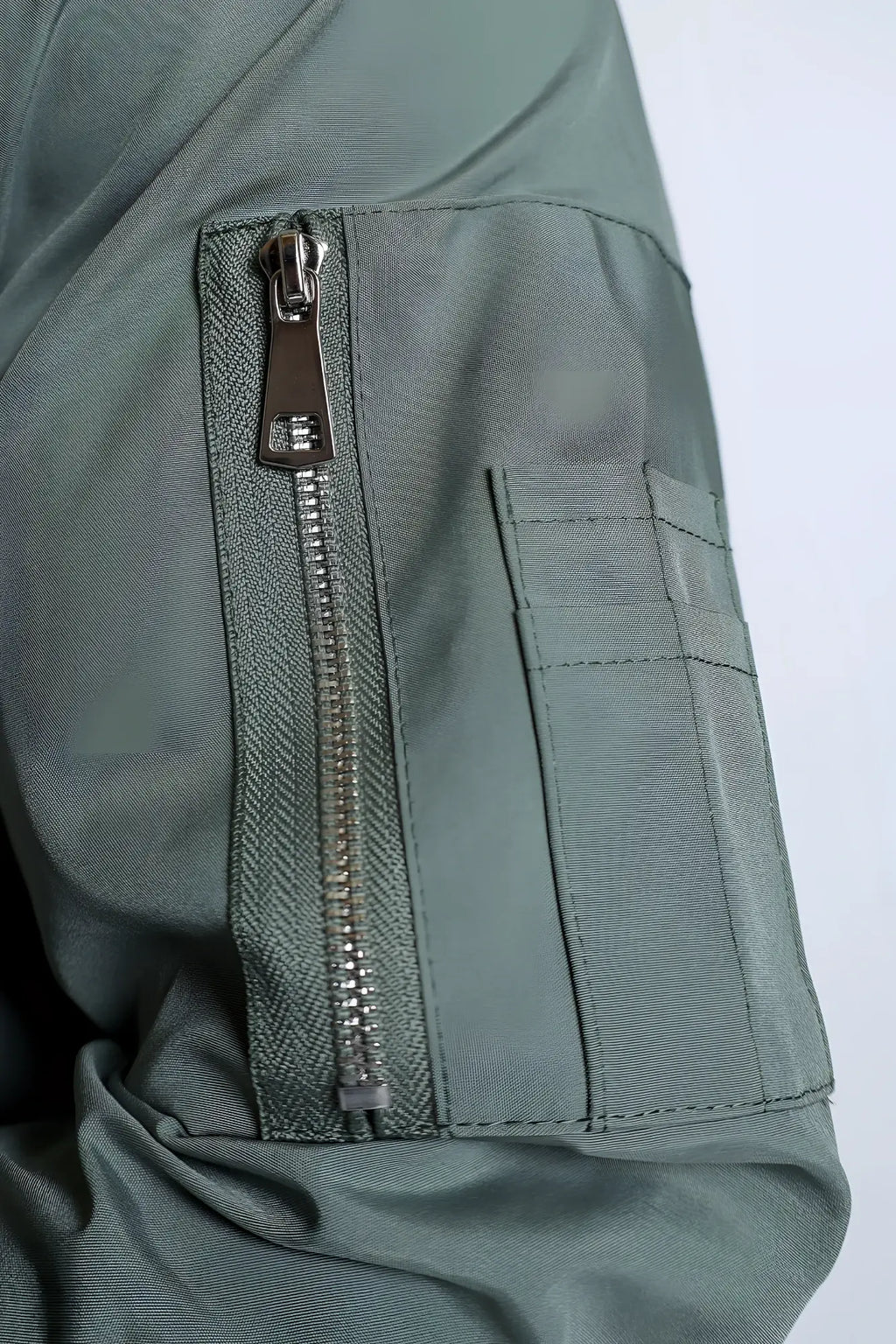 Men’s premium bomber jacket in olive green nylon with silver zipper and reinforced stitching for durability
