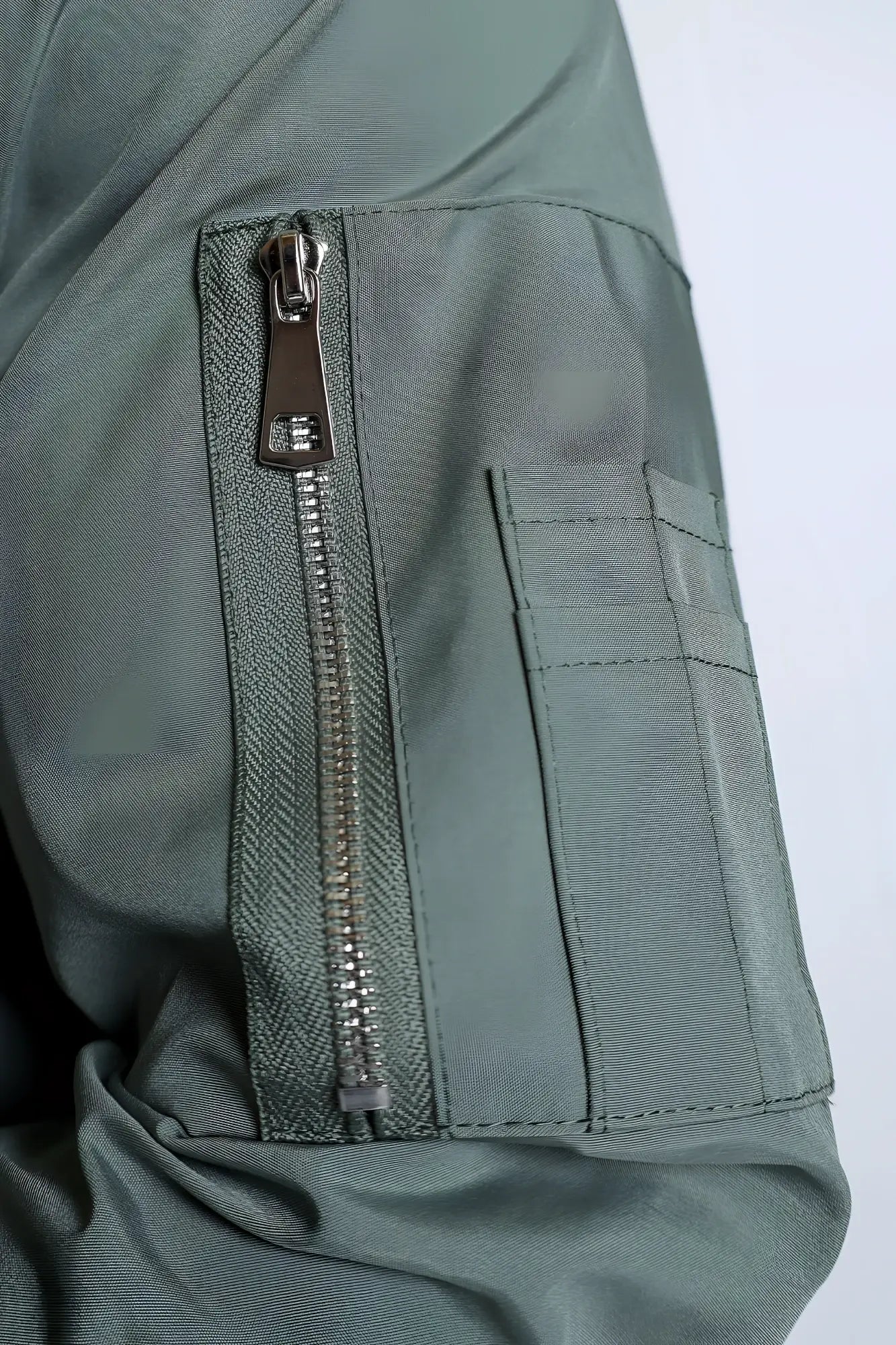 Men’s premium bomber jacket in olive green nylon with silver zipper and reinforced stitching for durability