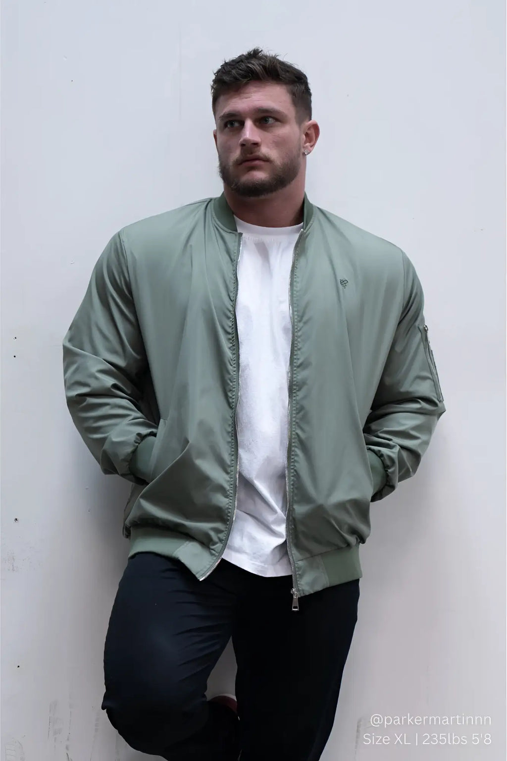 Men’s premium olive green bomber jacket with ribbed cuffs and subtle logo on left chest for casual wear
