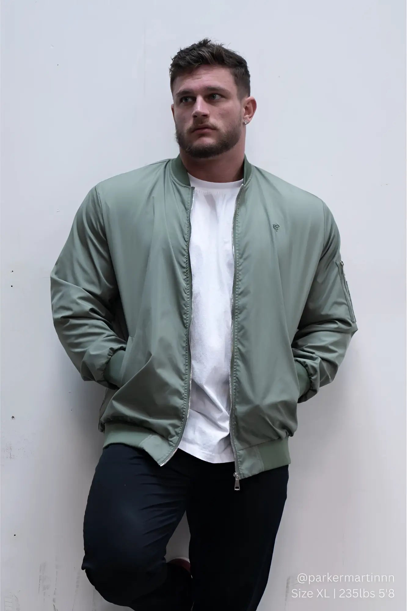 Men’s premium olive green bomber jacket with ribbed cuffs and subtle logo on left chest for casual wear