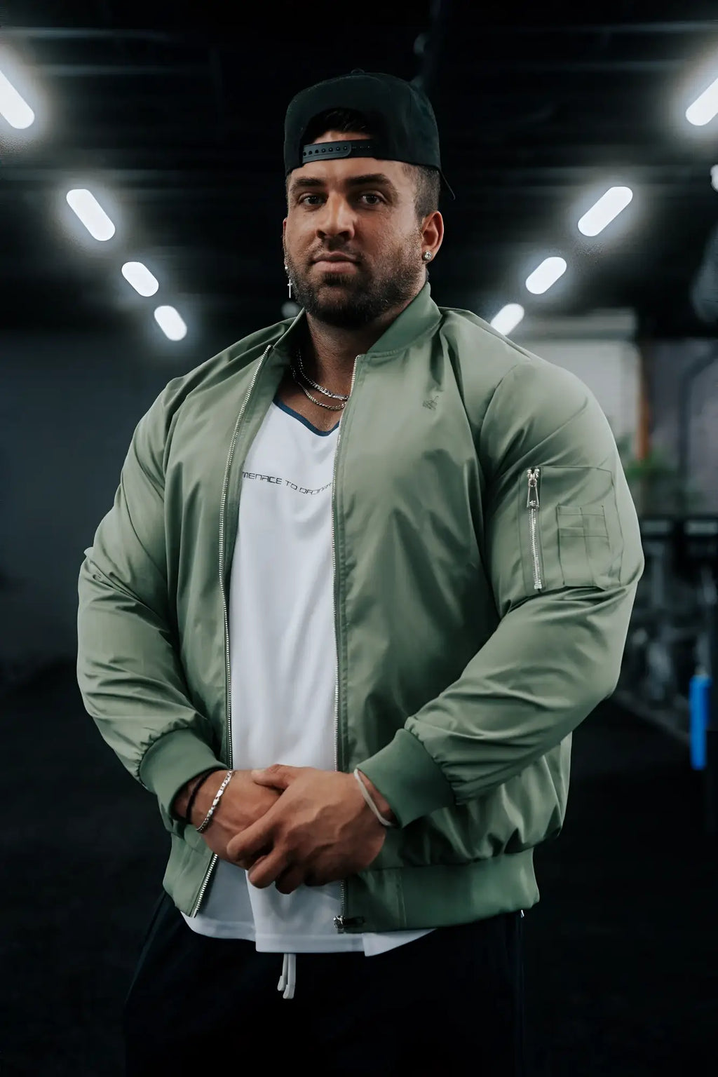 Men’s premium olive green bomber jacket with zippered pockets and ribbed cuffs made from durable material