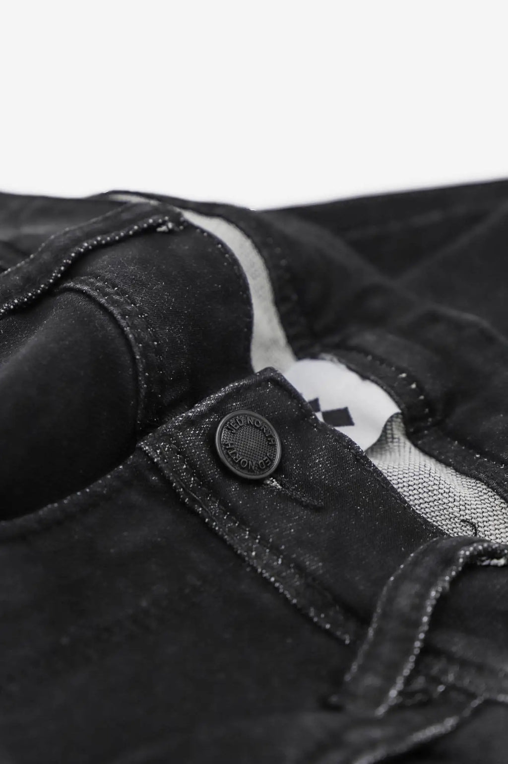 Men’s premium fitted stretchy black denim jeans with subtle faded texture and reinforced stitching at the waistband