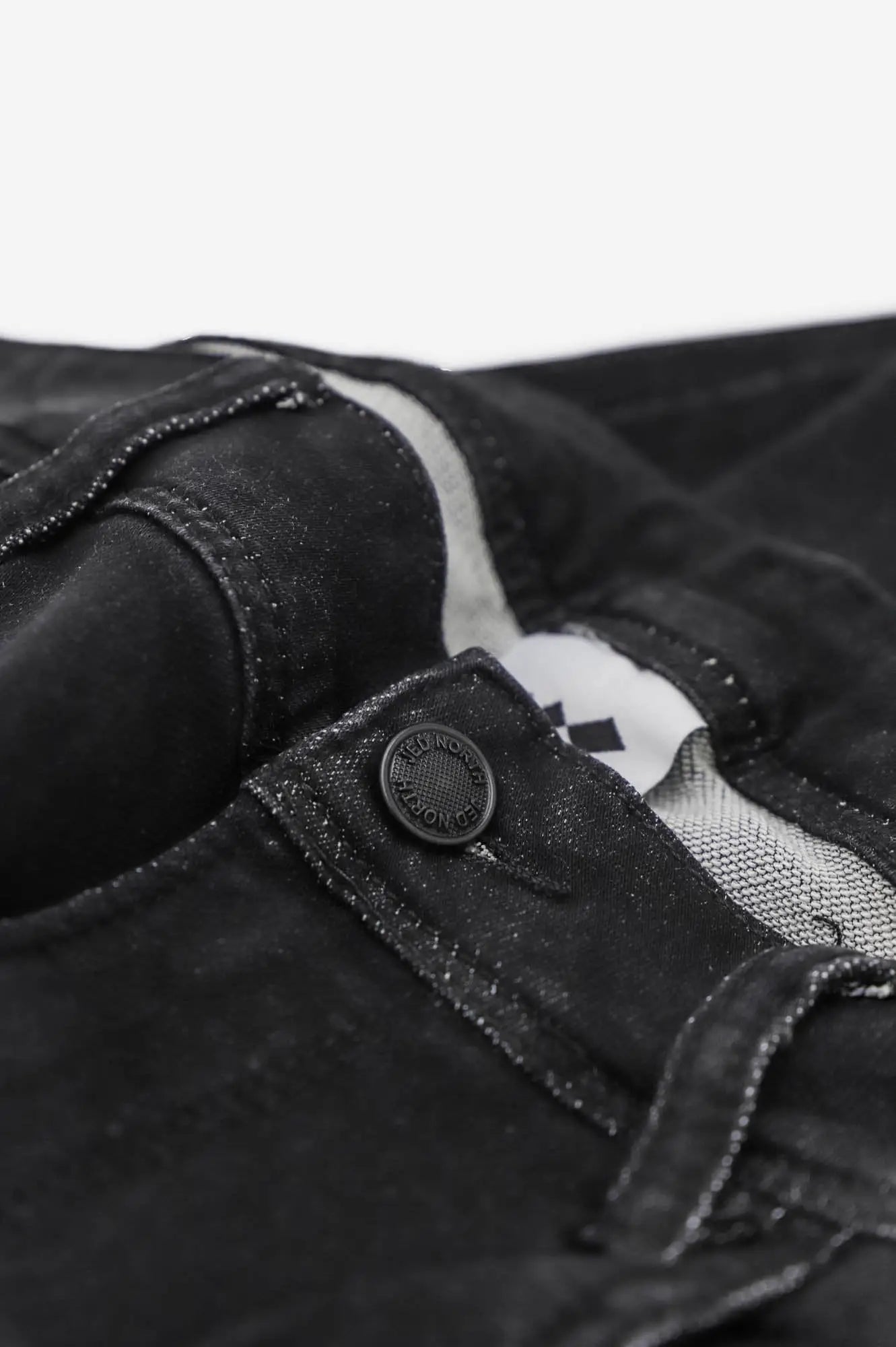 Men’s premium fitted stretchy black denim jeans with subtle faded texture and reinforced stitching at the waistband
