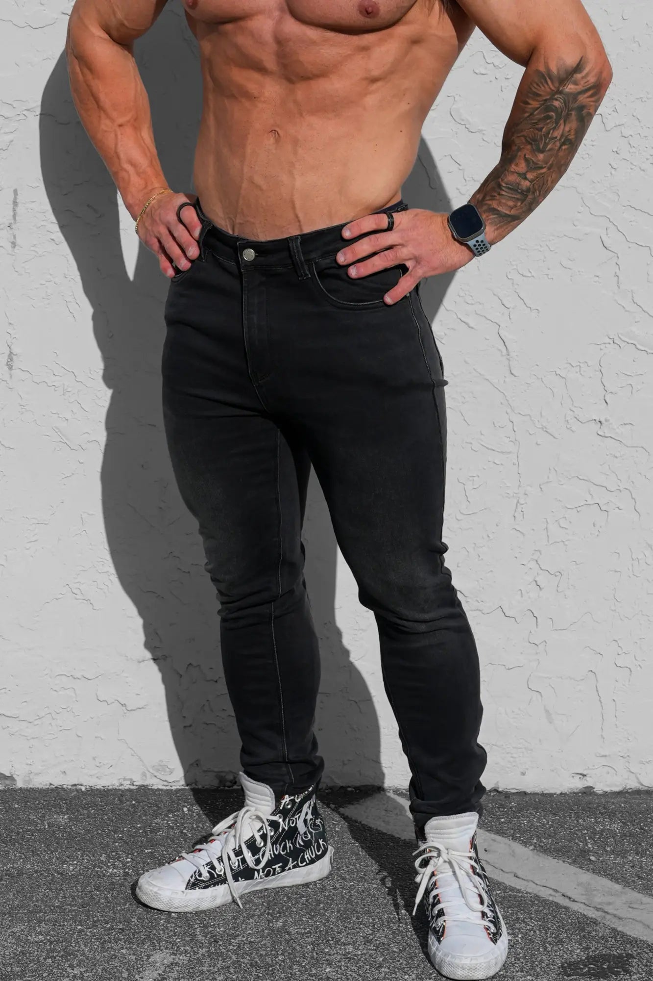 Men’s premium fitted stretchy black skinny-fit denim jeans with slim tapered leg and visible stitching details