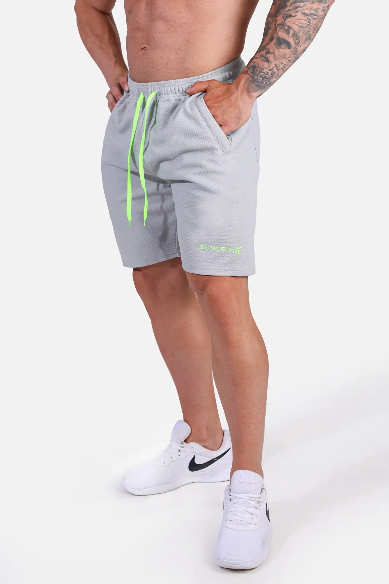 Men’s pro mesh shorts 8 inch in light gray with neon green drawstrings and embroidered logo on lower leg