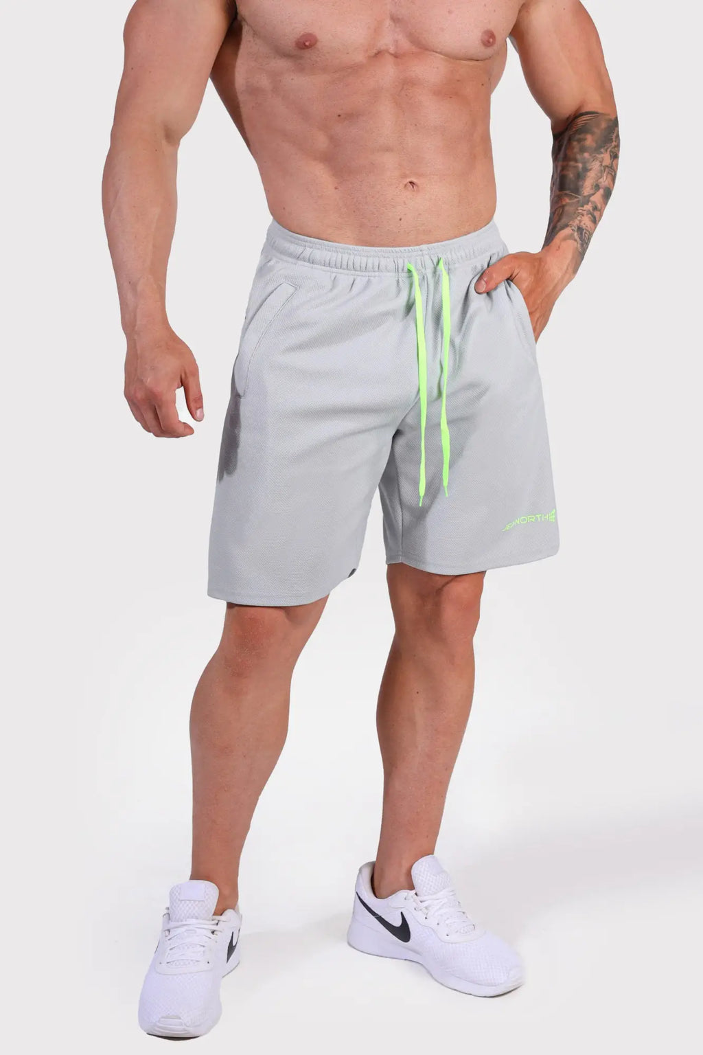 Men’s pro mesh shorts 8 inch in light gray with neon green drawstrings and subtle logo on lower right leg