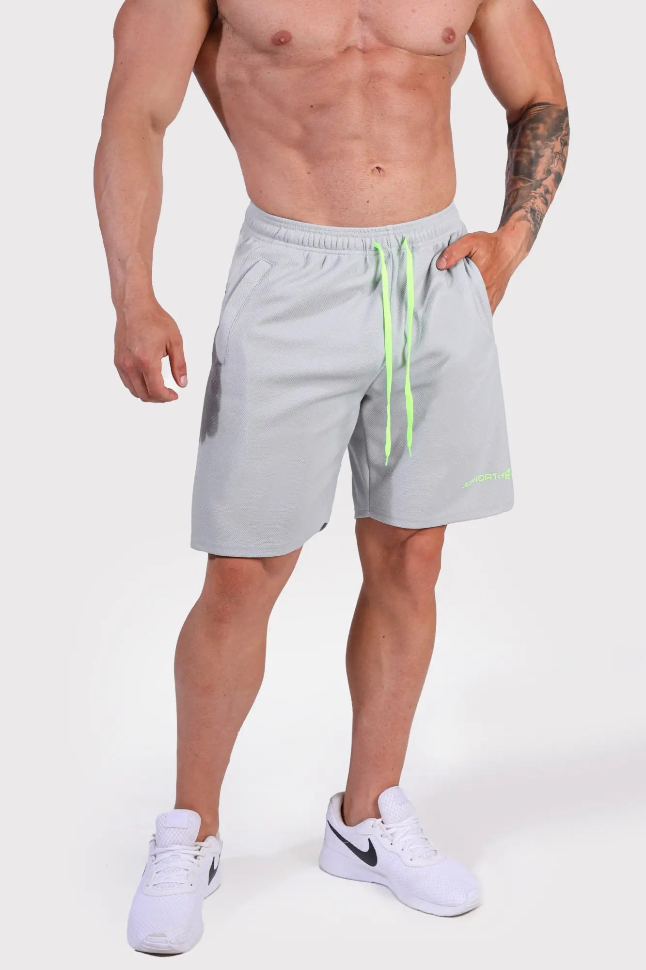 Men’s pro mesh shorts 8 inch in light gray with neon green drawstrings and subtle logo on lower right leg