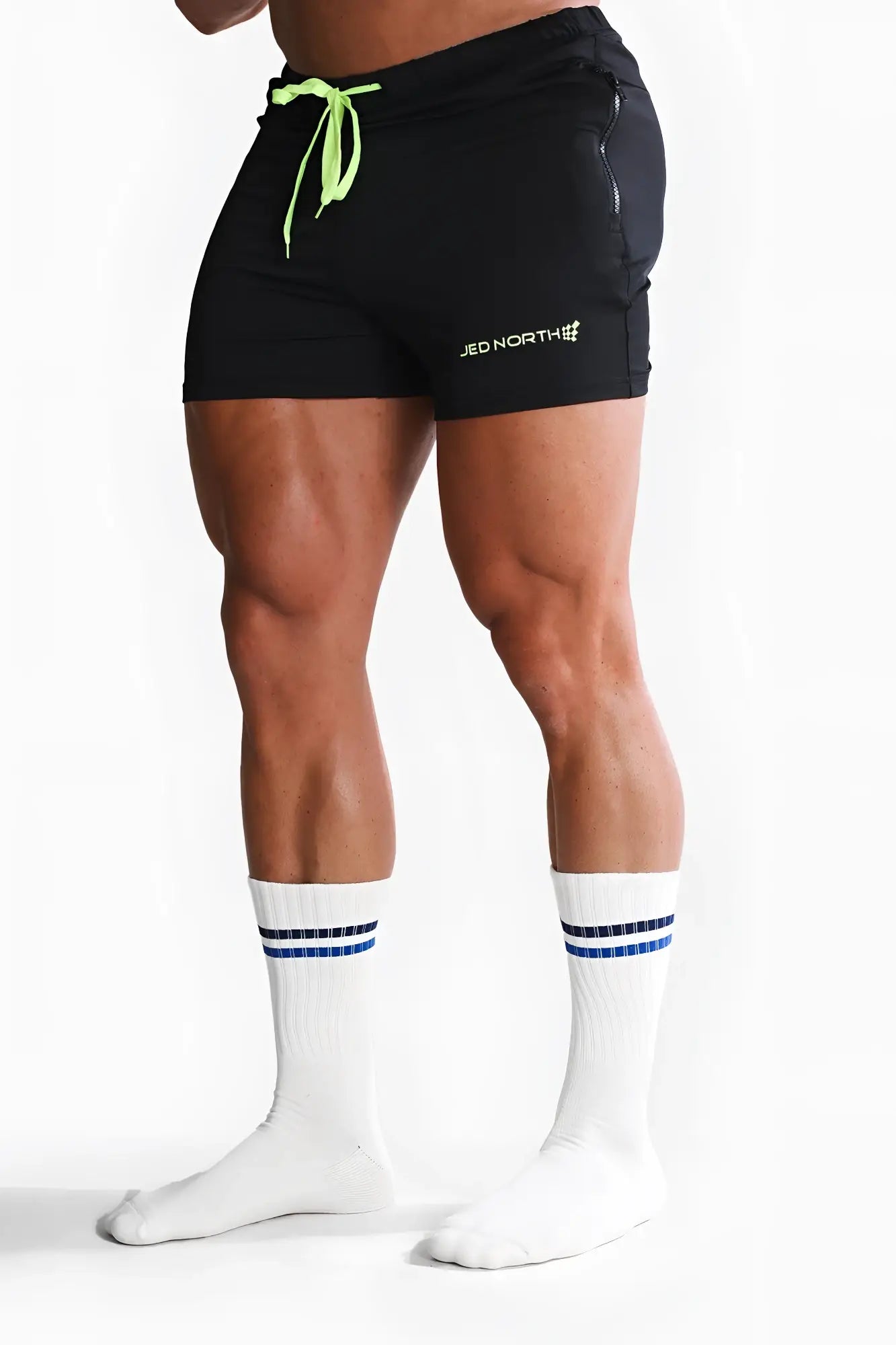Black athletic shorts with neon green drawstring and jed north logo on the side for men