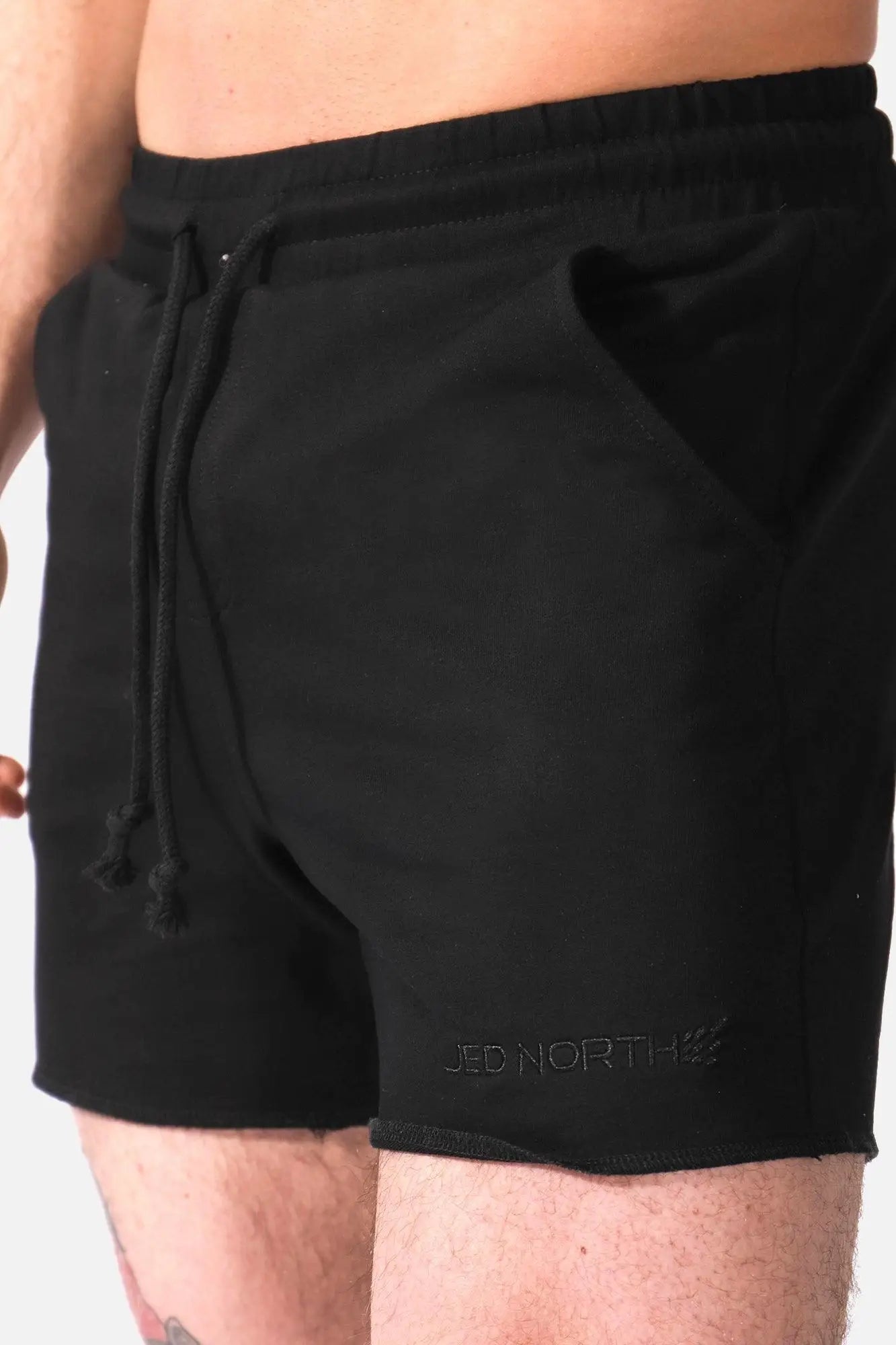 Black jed north motion 5 inch varsity sweat shorts with drawstring and subtle logo on lower right leg