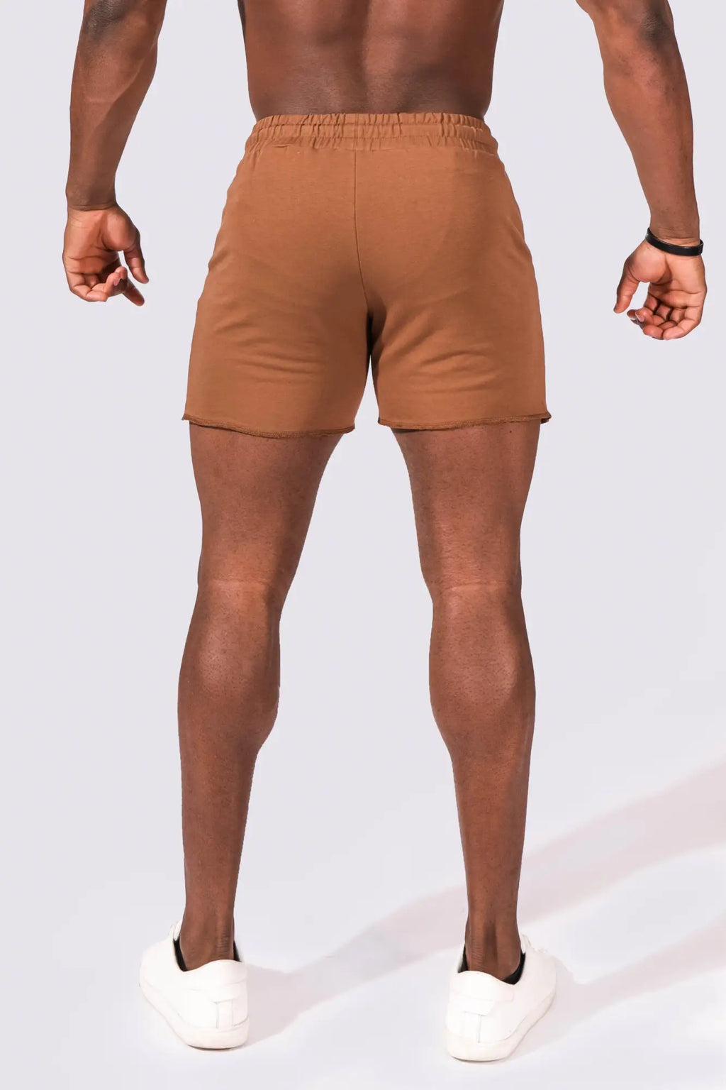 Tan motion 5 inch varsity sweat shorts with elastic waistband and minimalist design for athletic use