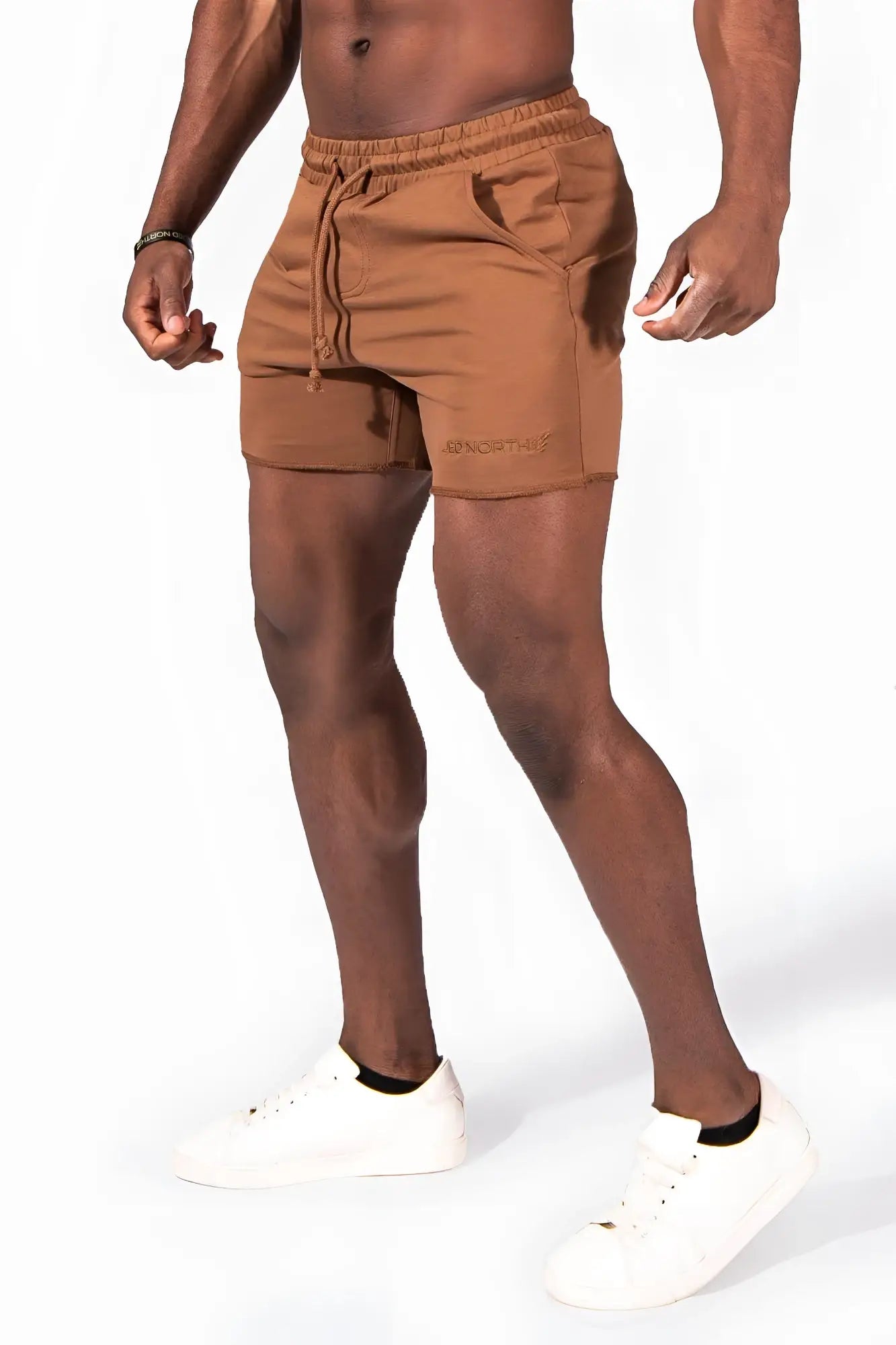 Tan Motion 5 inch varsity sweat shorts made of cotton with elastic waistband drawstring and embroidered logo on left leg