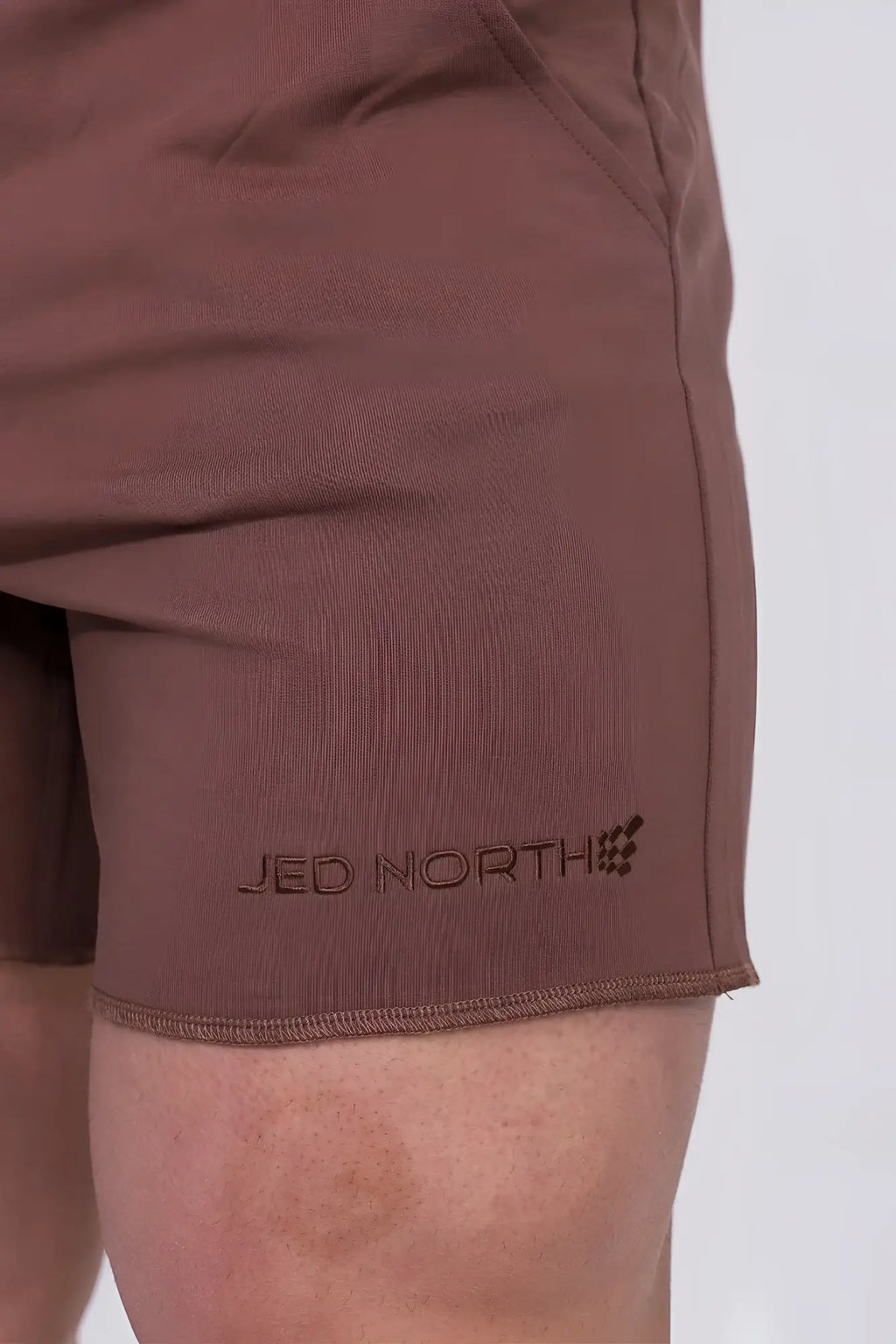 Brown cotton jed north motion 5 inch varsity sweat shorts with subtle logo embroidered on lower leg