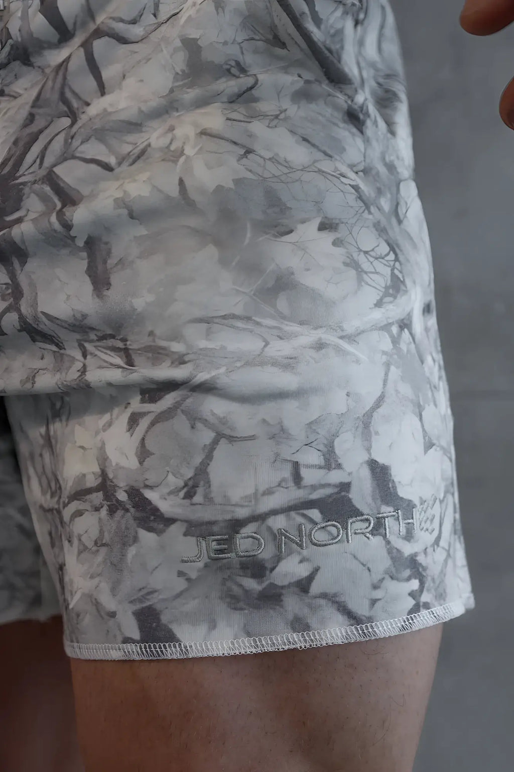 Motion 5 inch varsity sweat shorts in gray and white leaf camo with subtle jed north logo near the hem