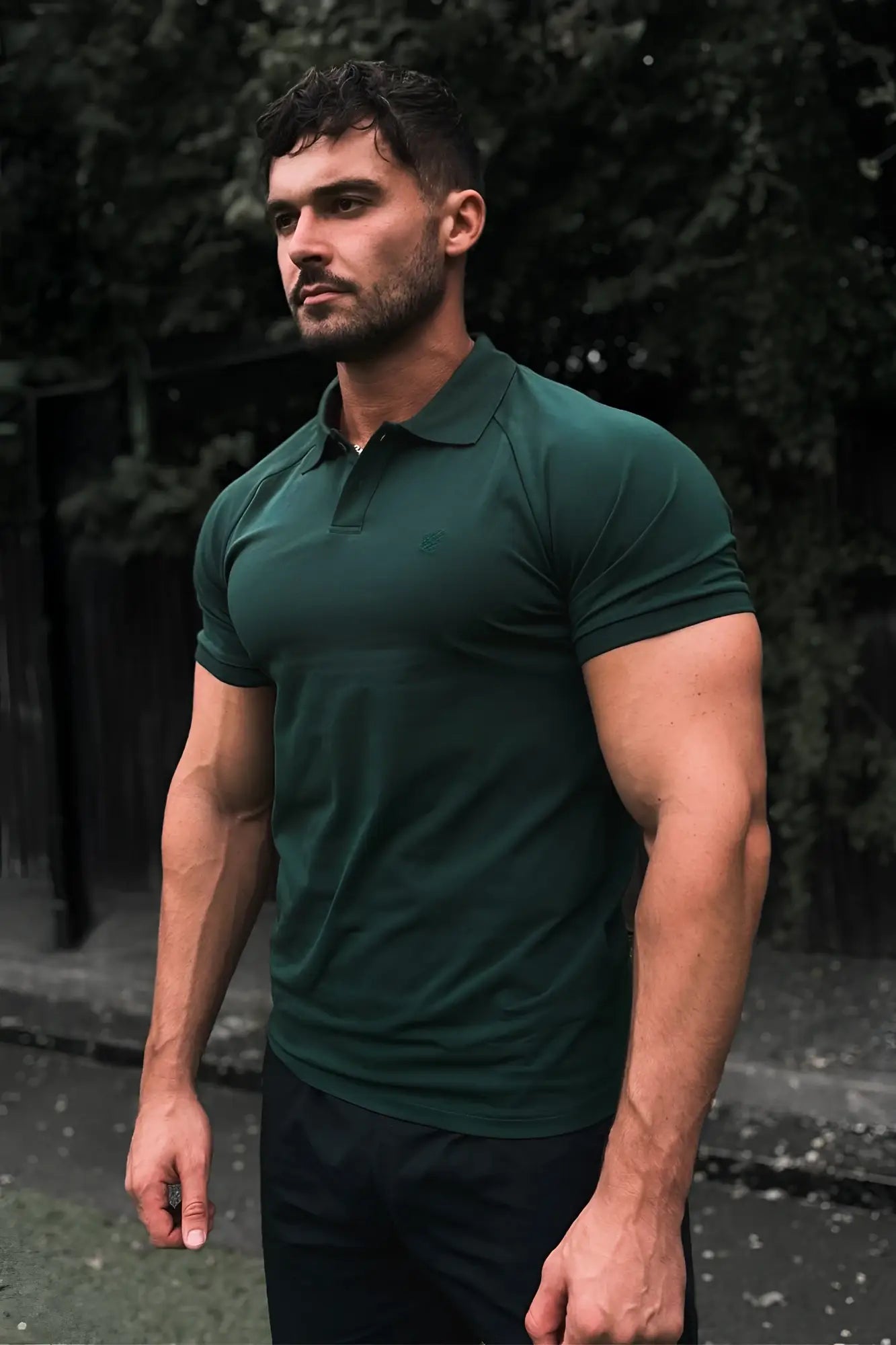 Dark green muscle fit all-day polo t-shirt with short sleeves classic collar and subtle ribbed texture in evergreen