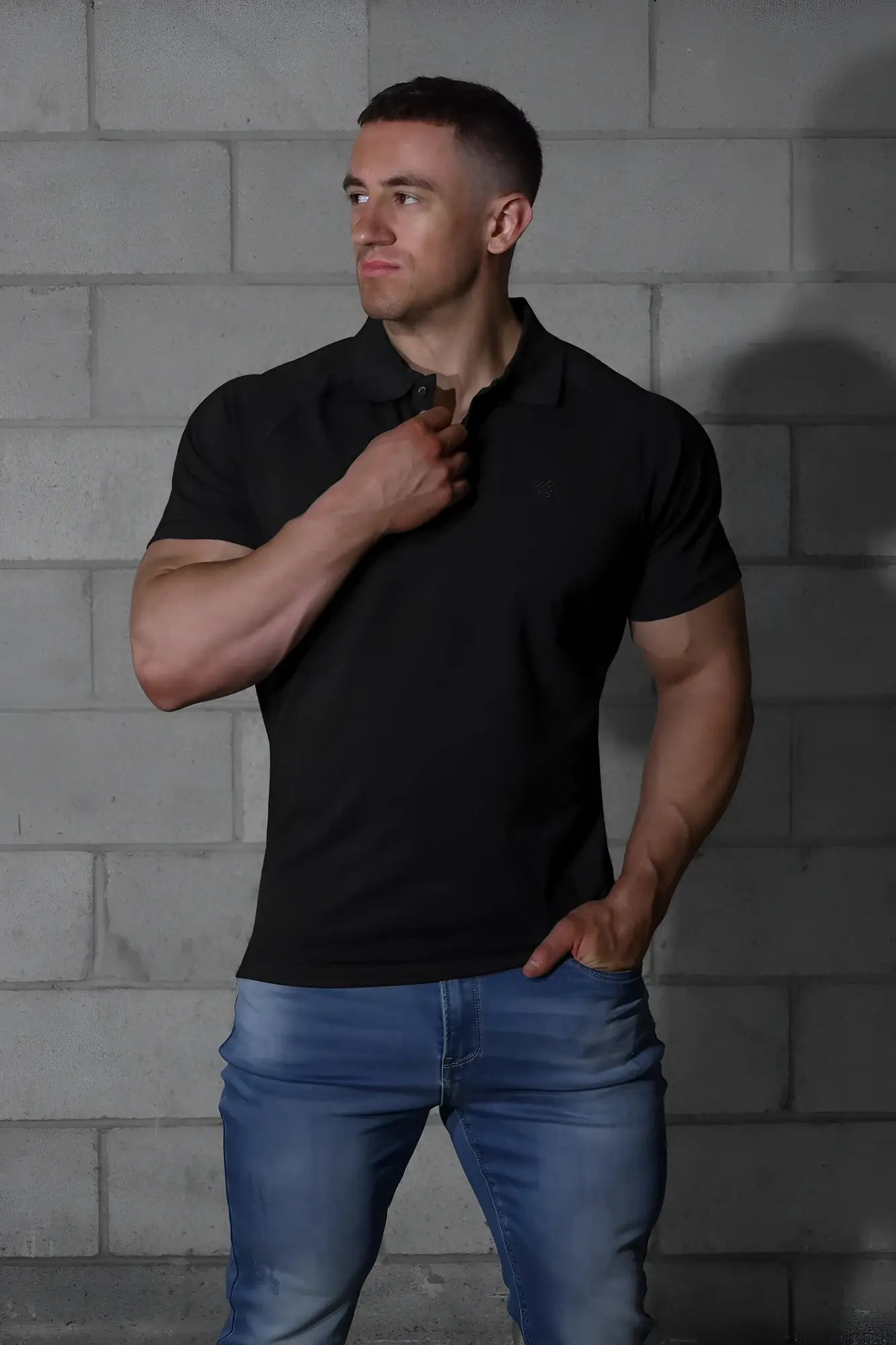 Black short-sleeved muscle fit polo shirt with classic collar and ribbed texture by Jed North in onyx black