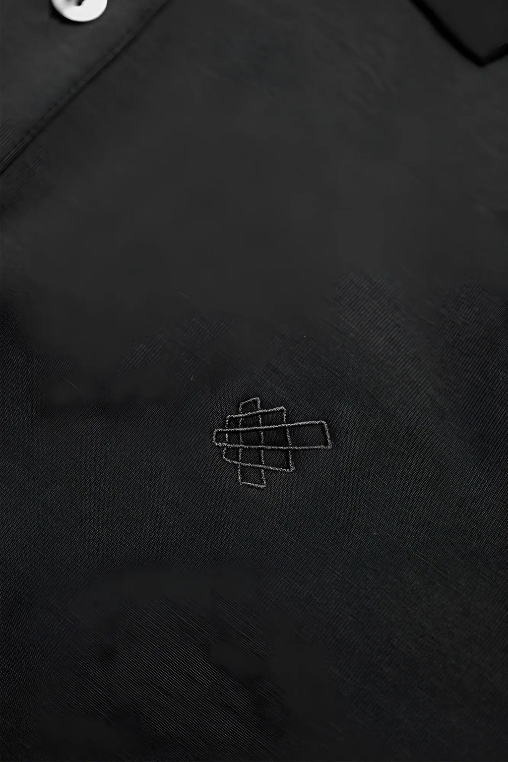 Jed North muscle fit all-day polo tshirt in onyx black with subtle white geometric logo embroidered on chest