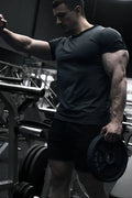 Black muscle-fit ringer t-shirt in stone gray with weight plate branding and central hole for barbell attachment