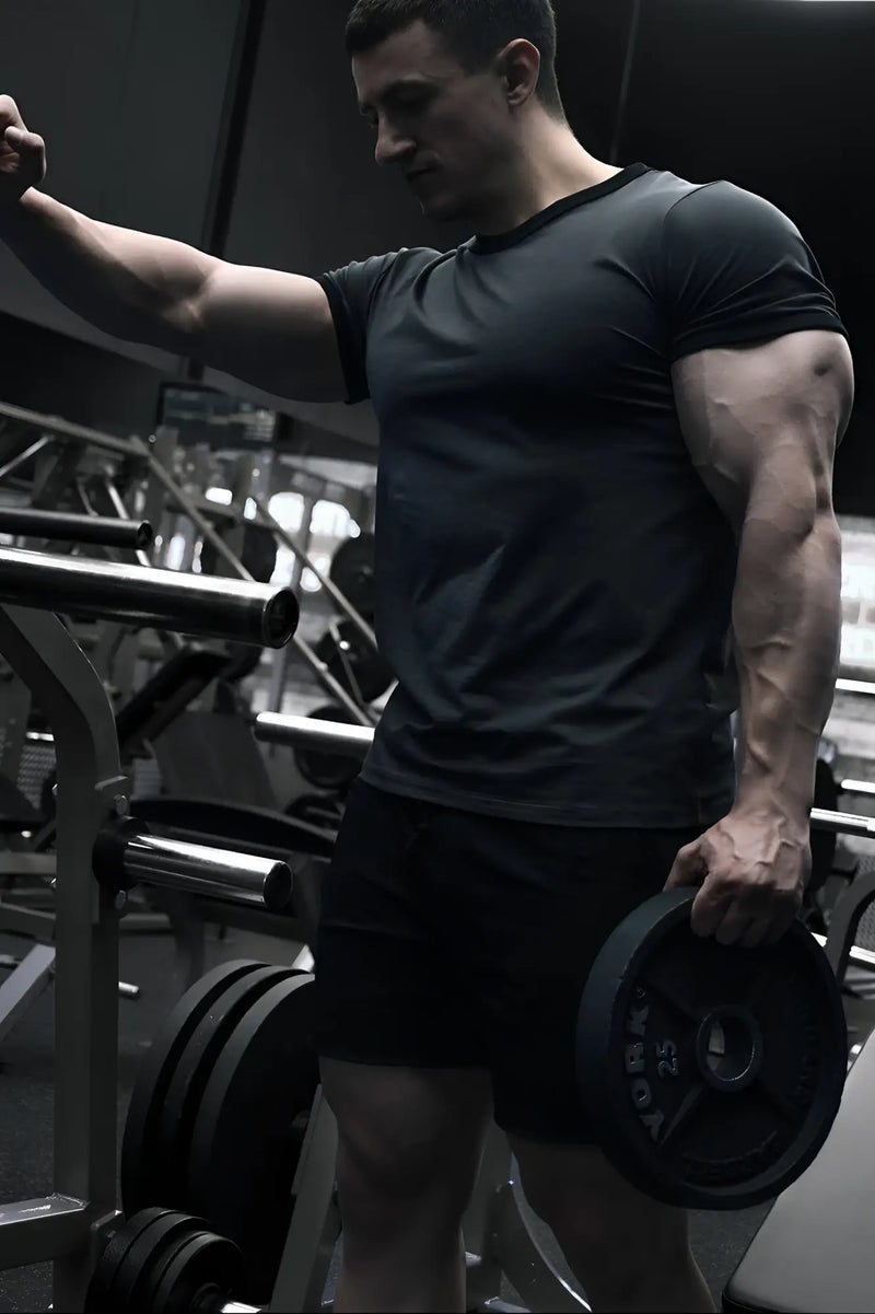 Black muscle-fit ringer t-shirt in stone gray with weight plate branding and central hole for barbell attachment