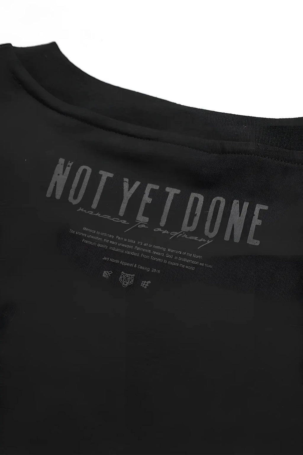 Oversized raw-cut cropped black cotton t-shirt with gray not yet done graphic printed inside the collar